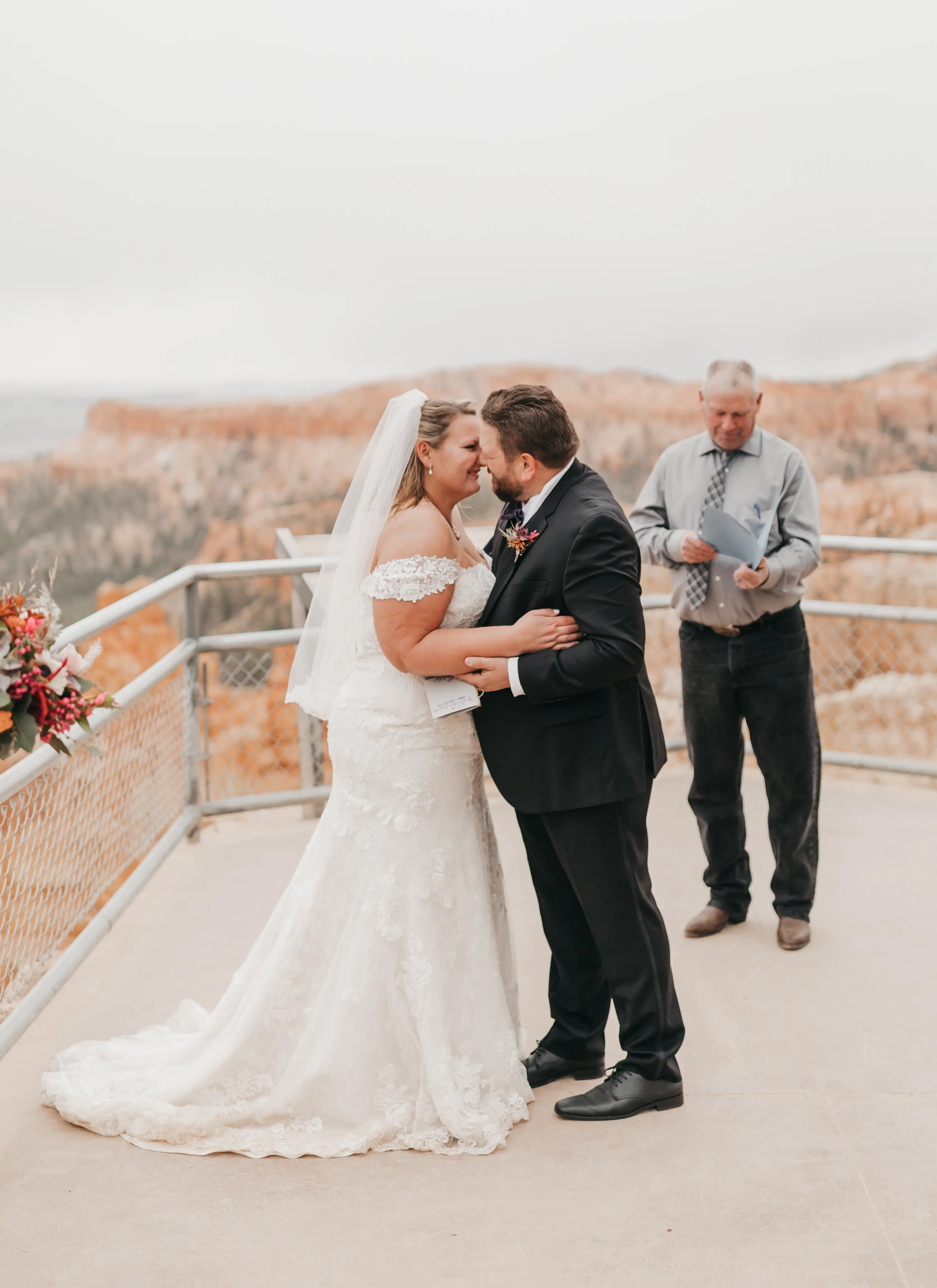 bride with groom in corset back fit and flare wedding dress