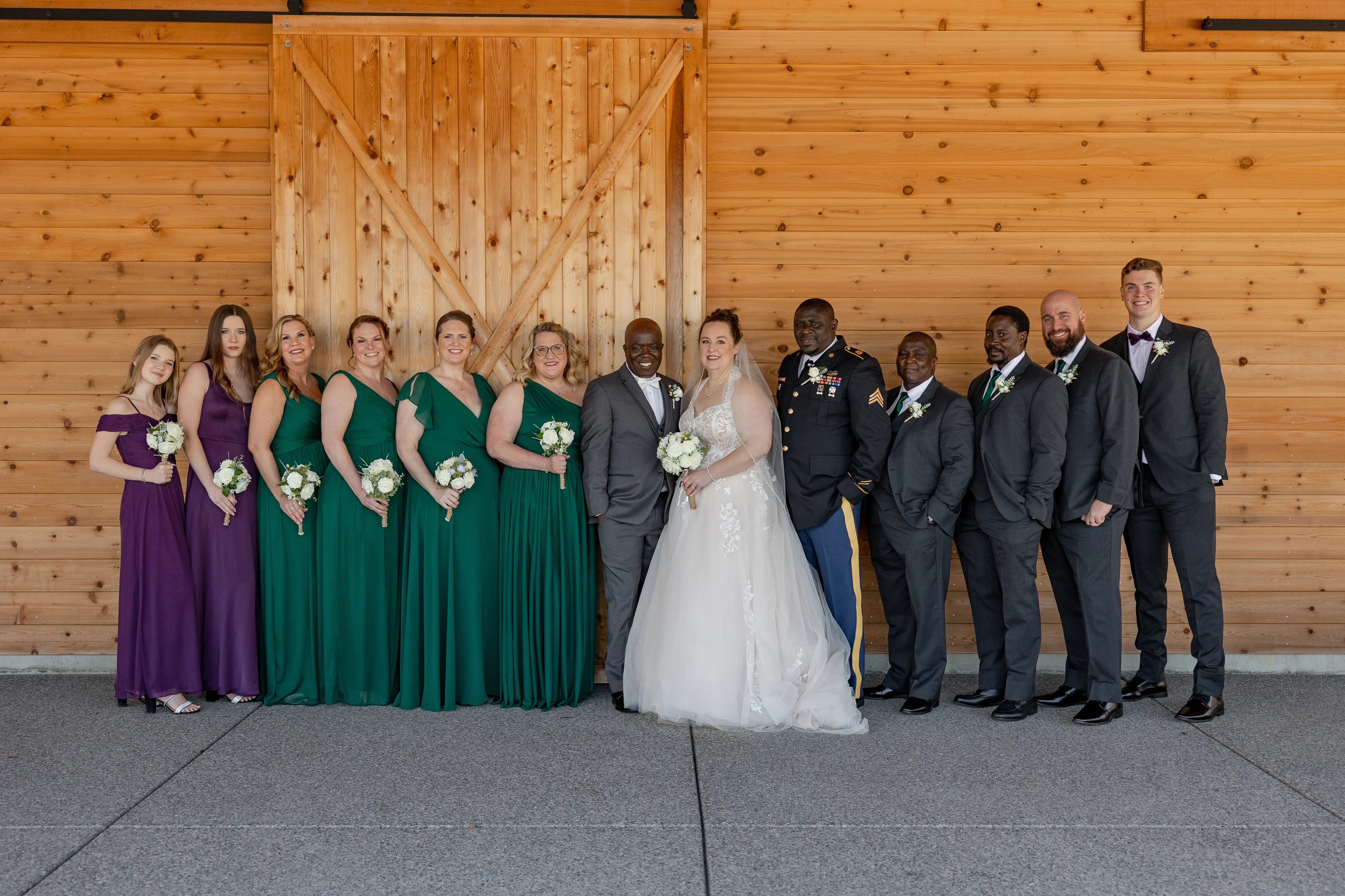 Bride In Ballgown Wedding Dress Called Harlem By Maggie Sottero With Groom With Bridal Party In Green And Purple