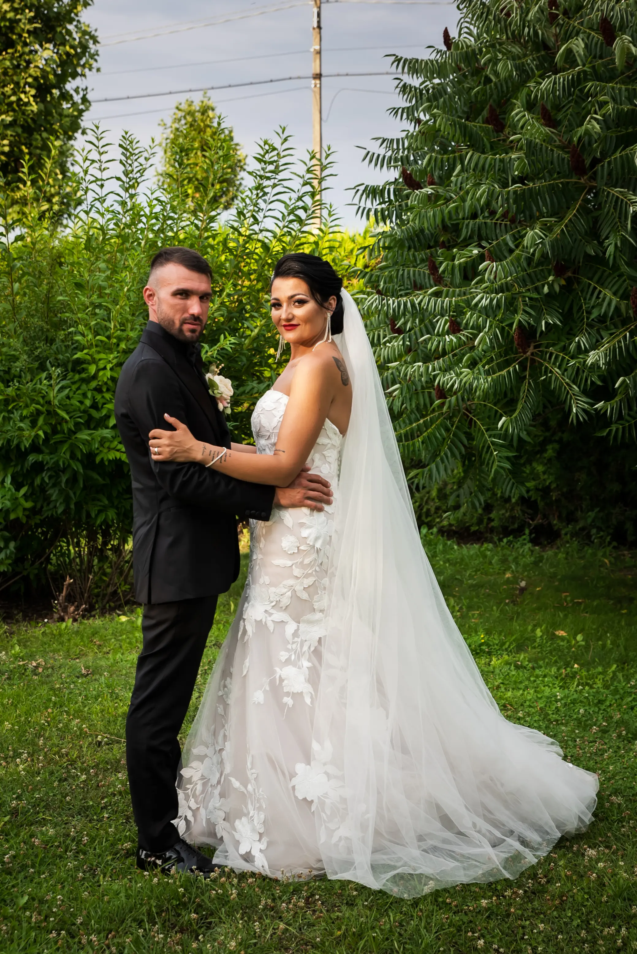 Bride Wearing Lace Mermaid Wedding Gown Called Hattie By Rebecca Ingram Holding Groom