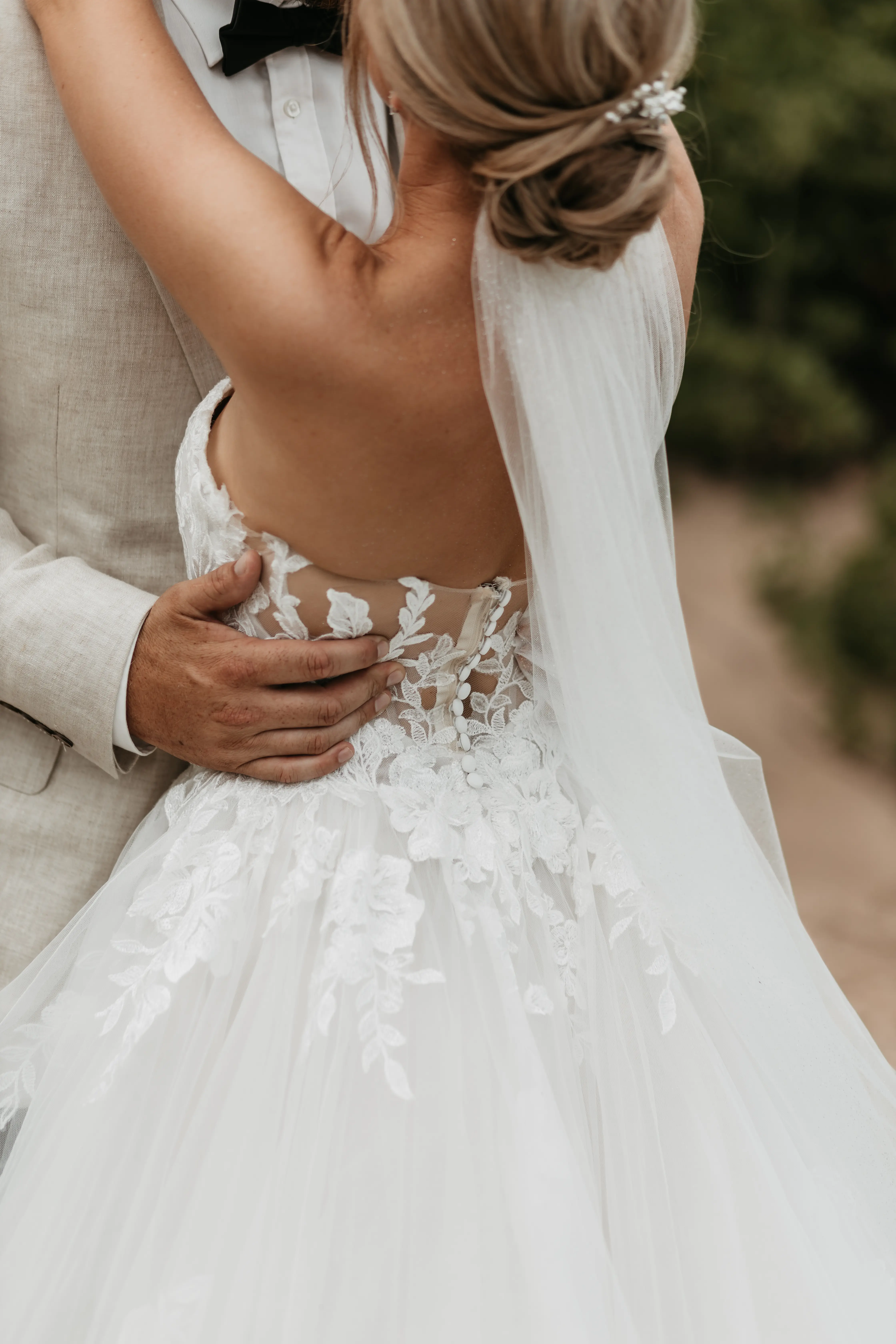 Bride wearing Indiana by Maggie Sottero looking up at her husband