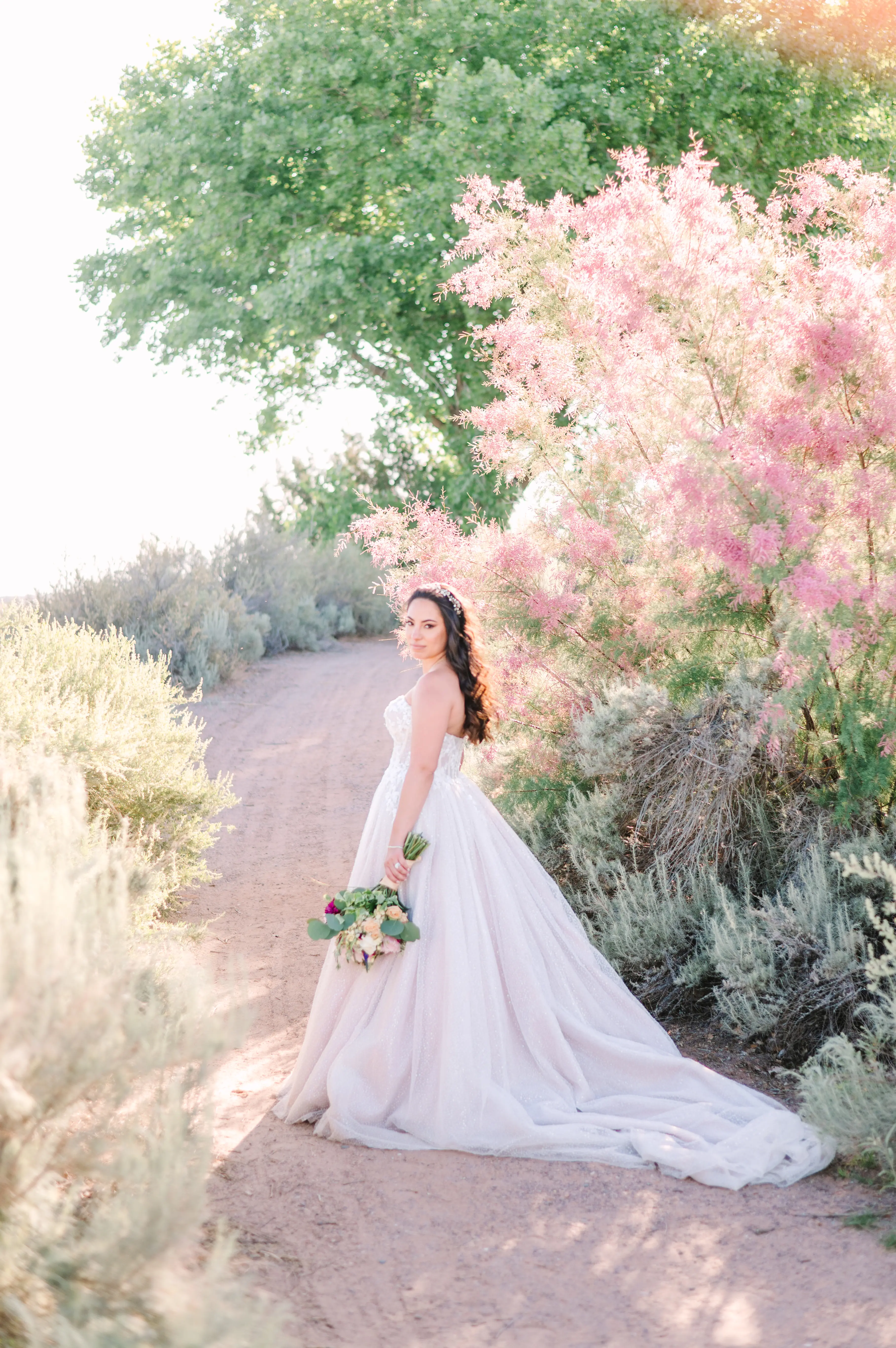 Bride In White Wedding Dress Named Shasta By Sottero and Midgley With Flowers