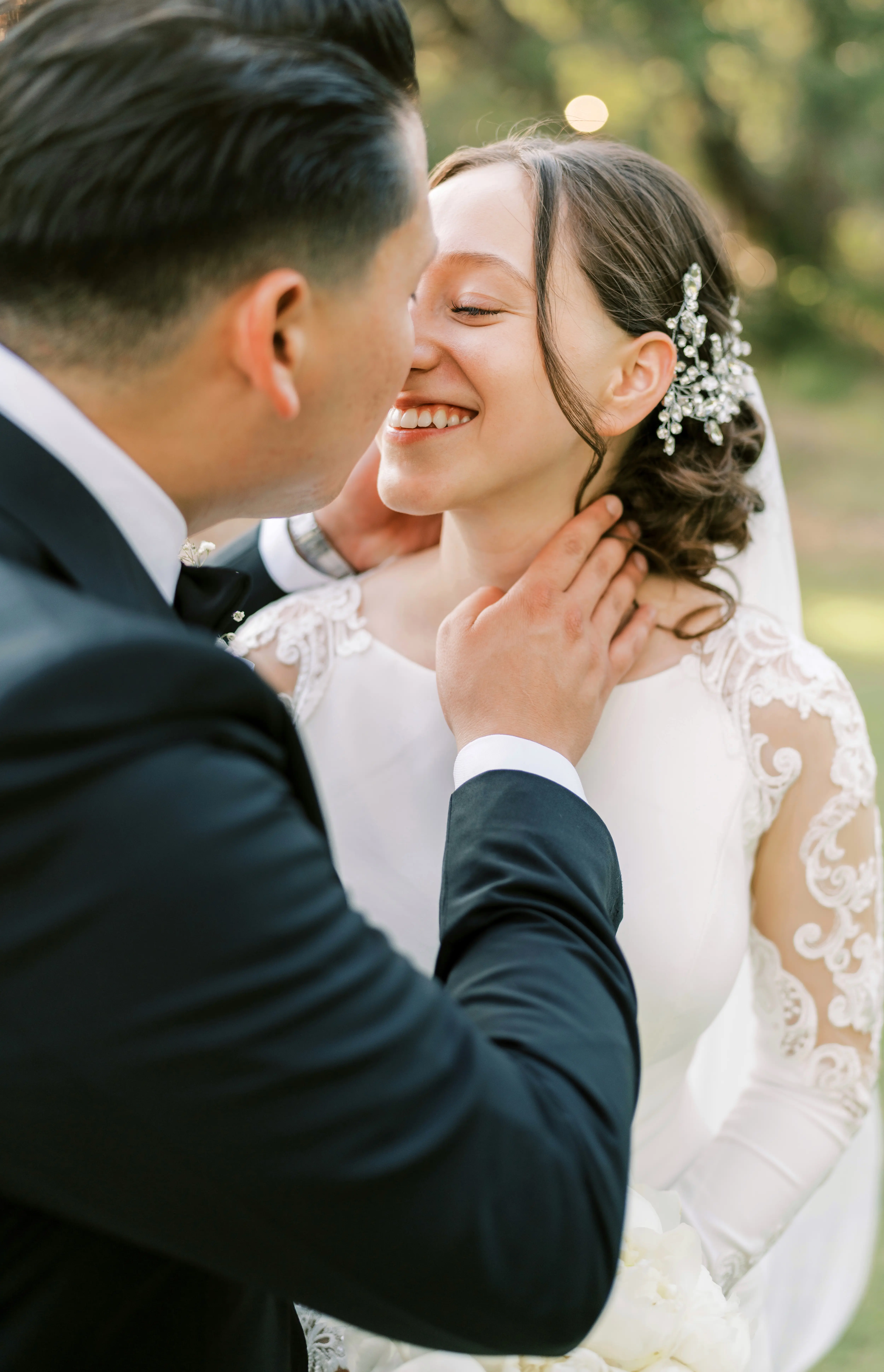 Bride Wearing Simple Long Sleeve Wedding Dress Called Bethany By Rebecca Ingram Kissing Groom