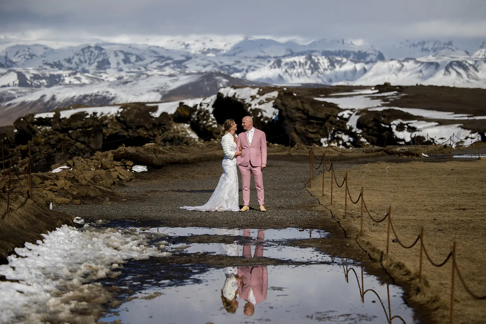 Bride wearing Tuscany Lynette by Maggie Sottero with her husband in the snow