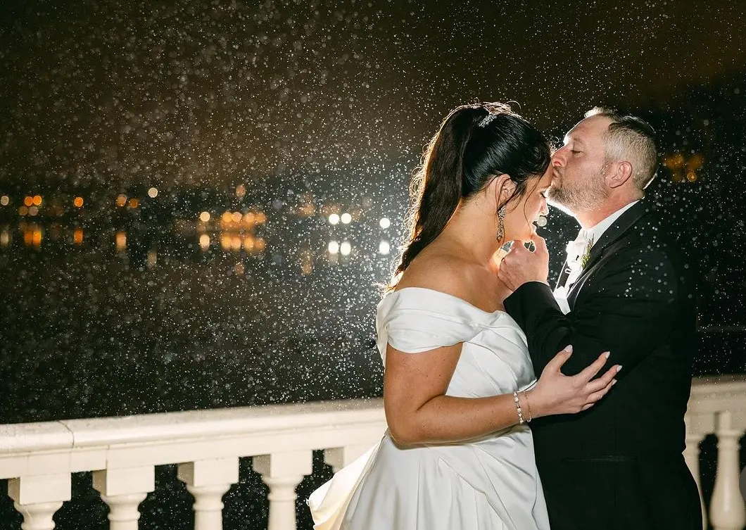 Bride wearing Ekaterina by Maggie Sottero being kissed on the head