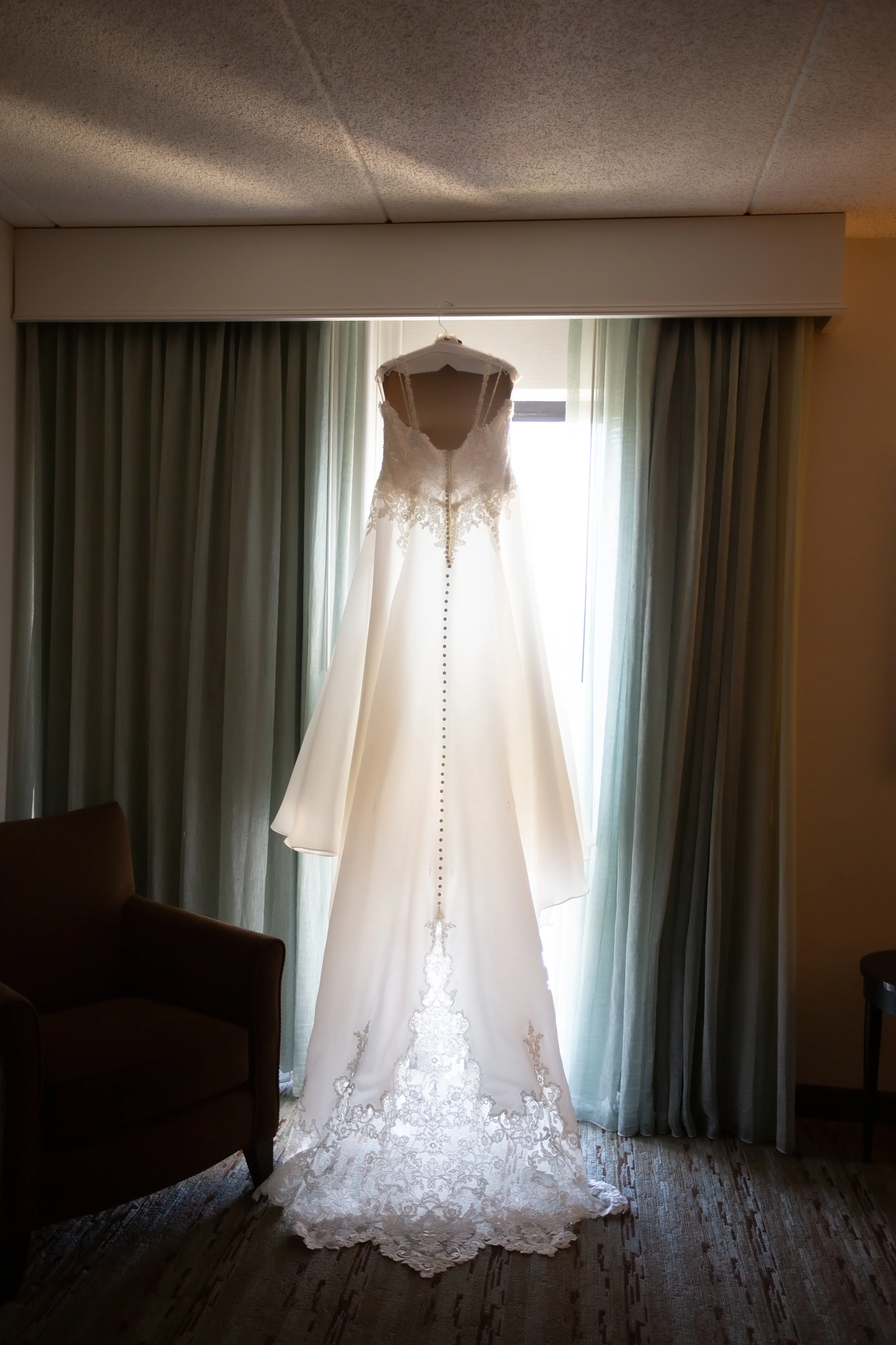 Lace Ballgown Wedding Dress Called Savannah By Maggie Sottero Hanging From A Window