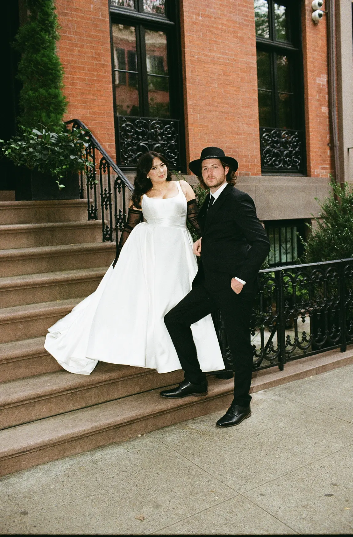 Bride Wearing Simple Aline Wedding Dress Called Selena By Maggie Sottero With Groom Standing On Steps