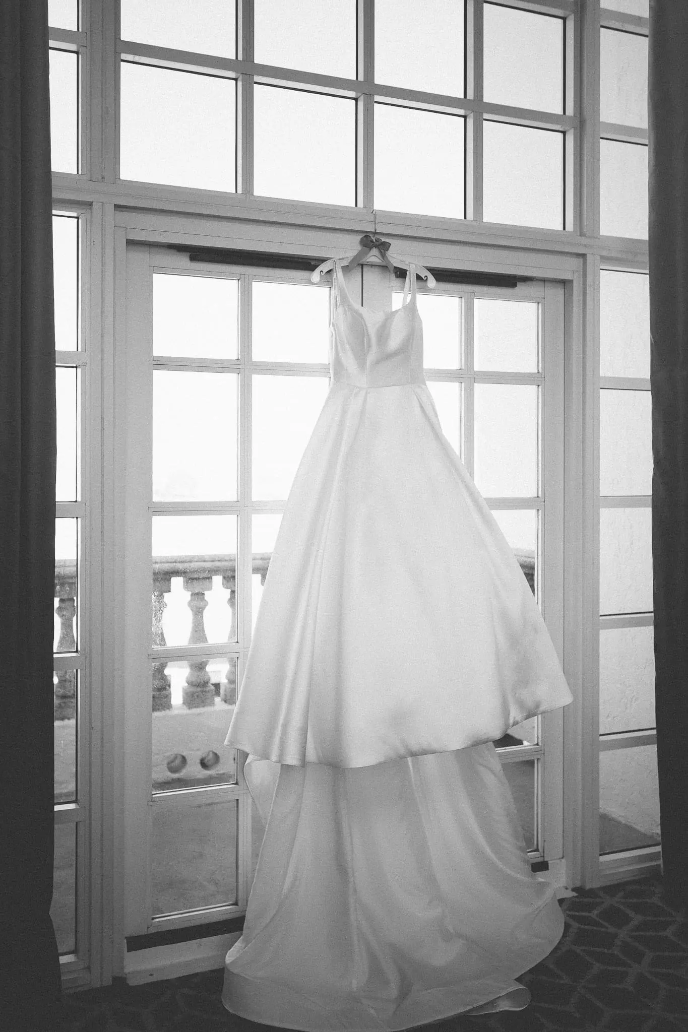 White Satin Ball Gown Wedding Dress Called Selena By Maggie Sottero Hanging By A Window