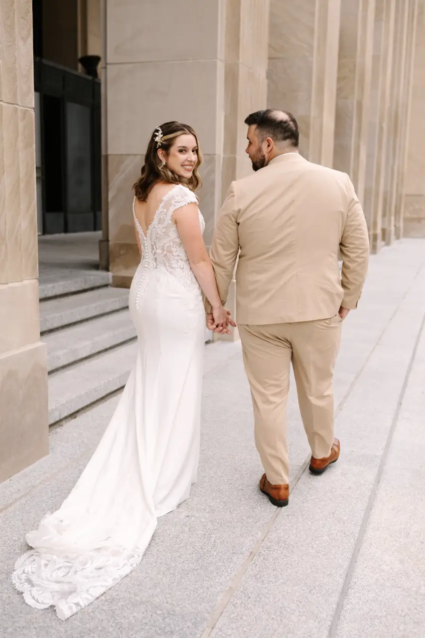 Bride Wearing Crepe Lace Wedding Dress Called Anson By Sottero And Midgley Holding Hands With Groom
