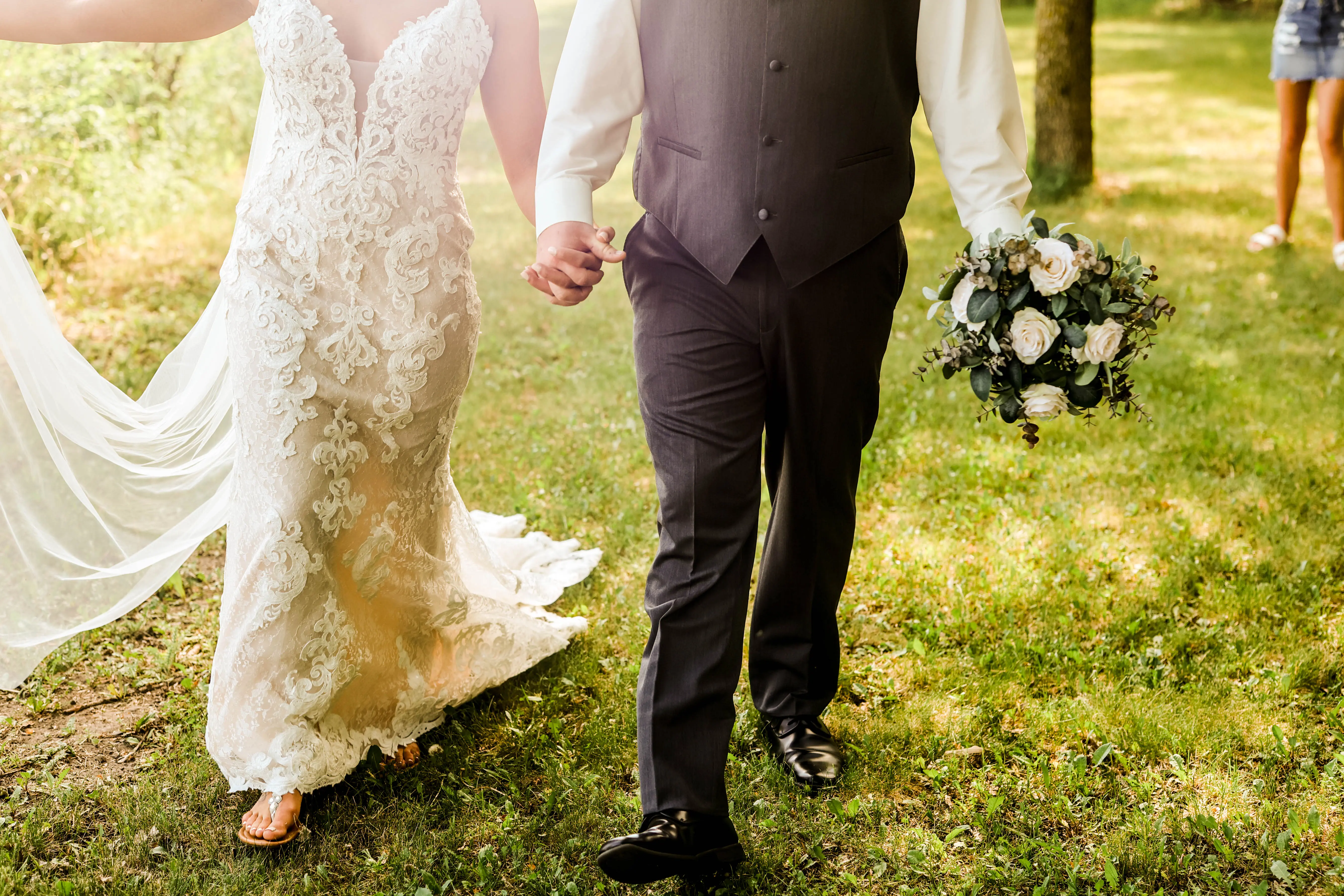 Bride with groom wearing romantic lace sheath wedding dress