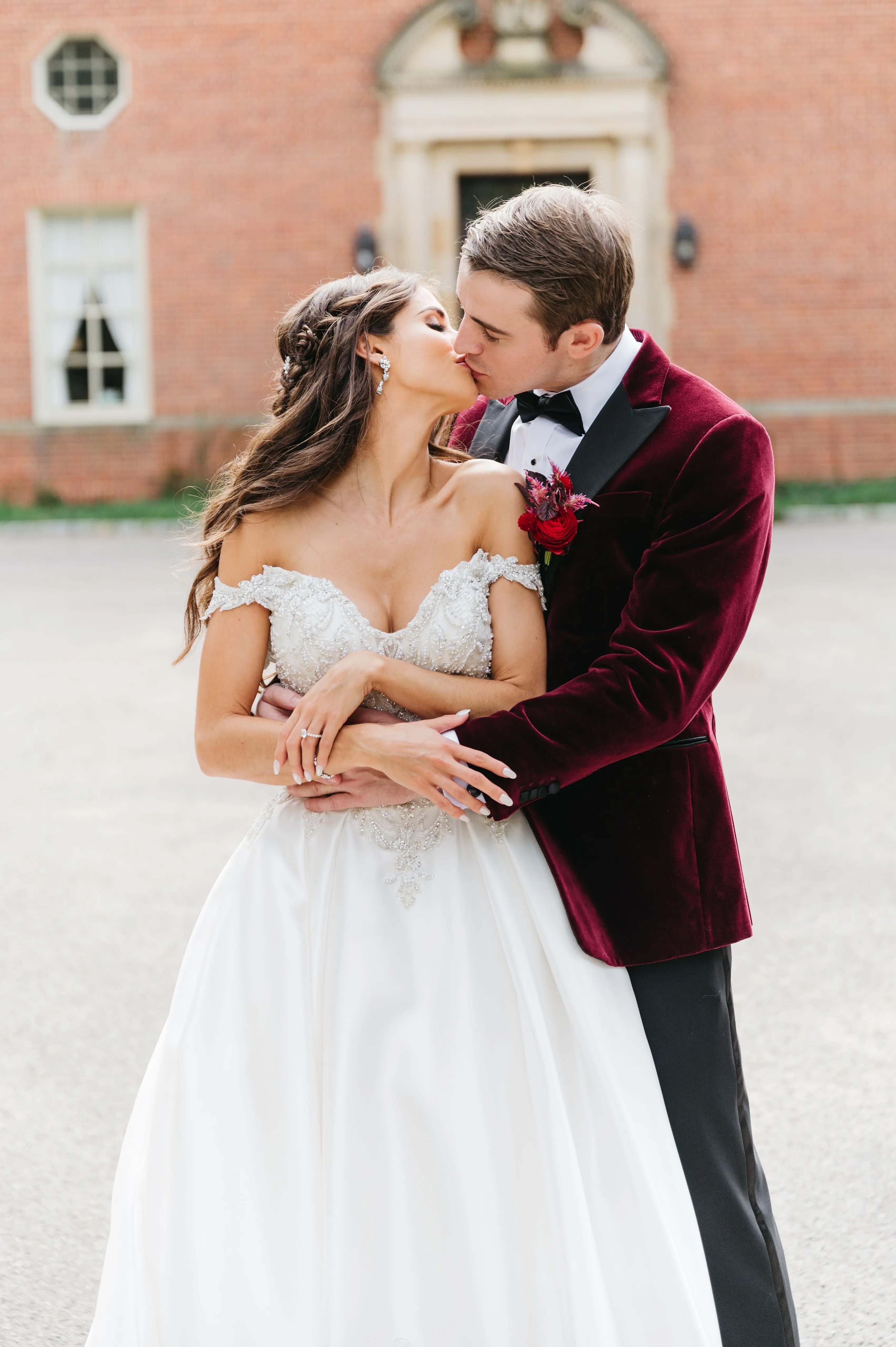 Bride In Satin Ballgown Wedding Dress Called Kimora By Sottero And Midgley With Groom In Velvet Red Suit