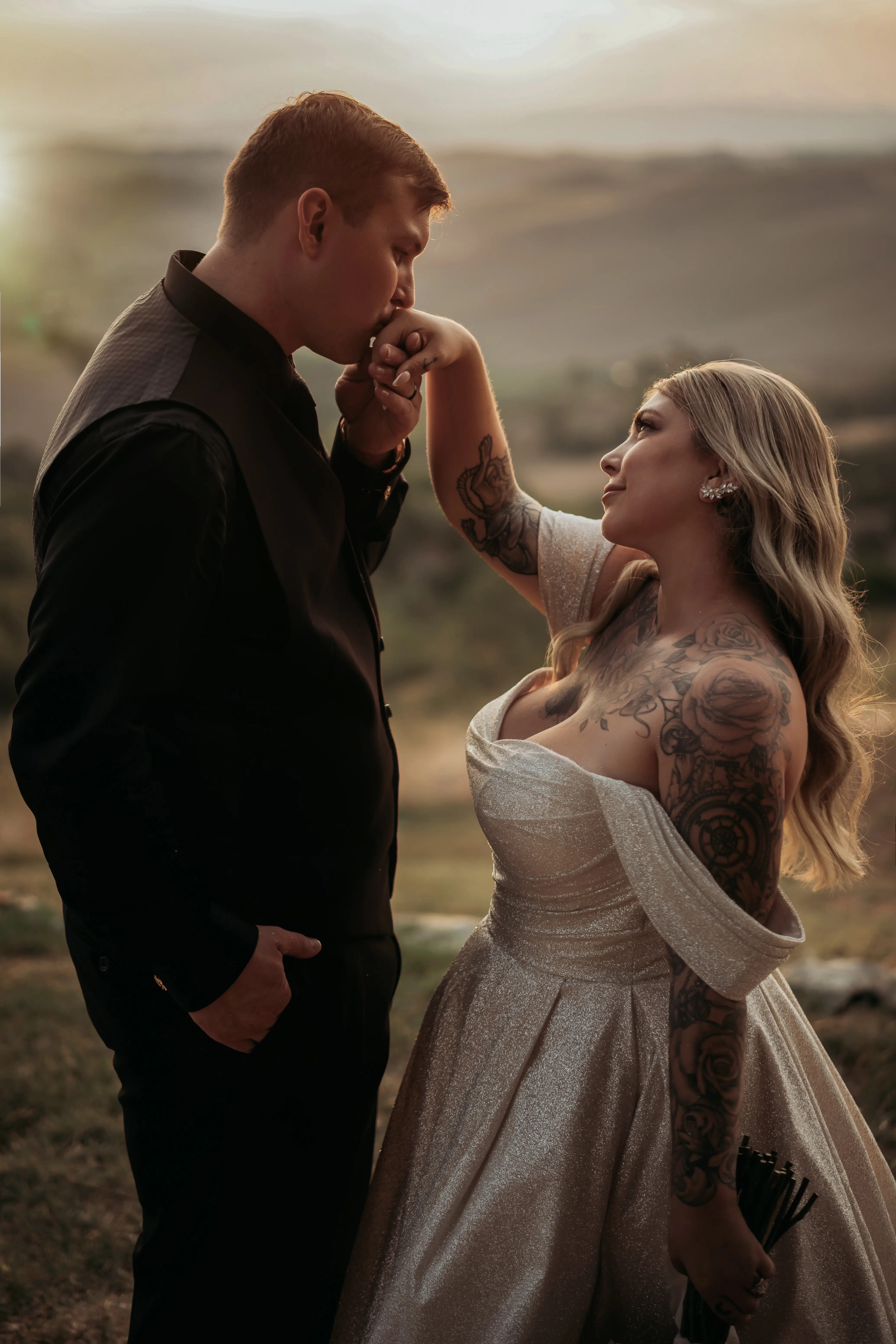 Bride wearing Anniston by Maggie Sottero having her hand kissed by her husband