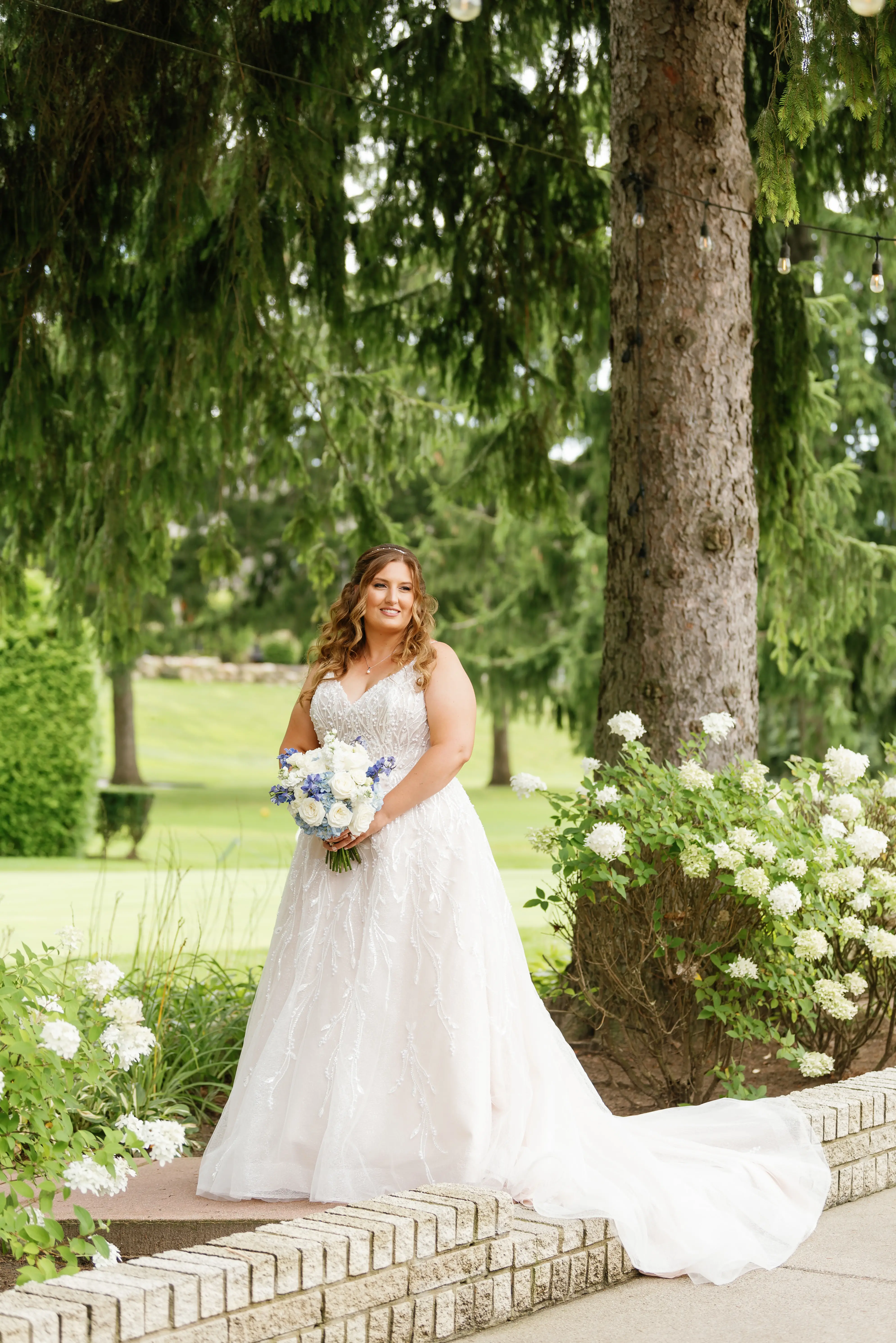 Bride Wearing Beaded Wedding Dress Called Marvine By Sottero And Midgley In A Garden