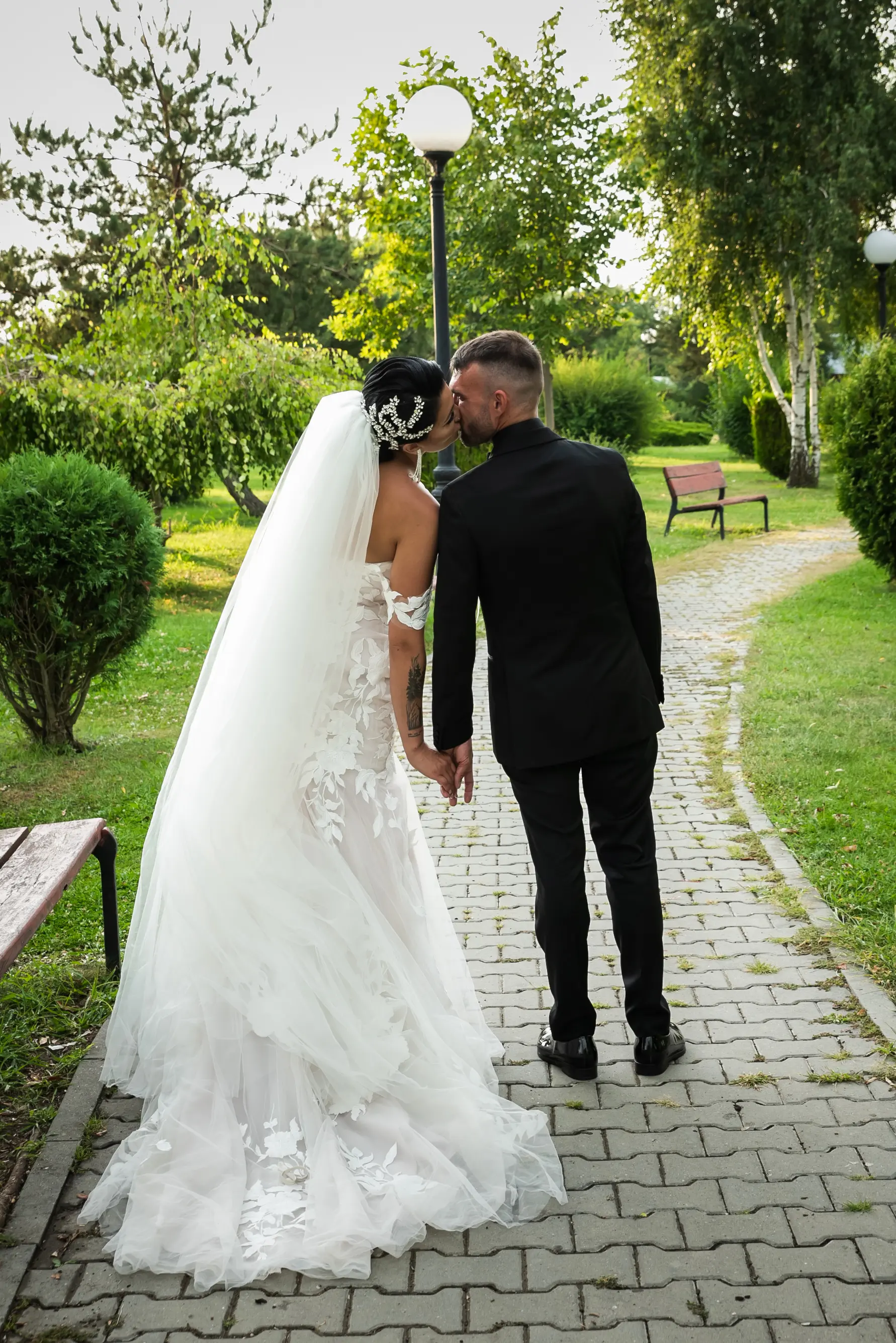 Bride Wearing Lace Mermaid Wedding Gown Called Hattie By Rebecca Ingram Kissing Groom