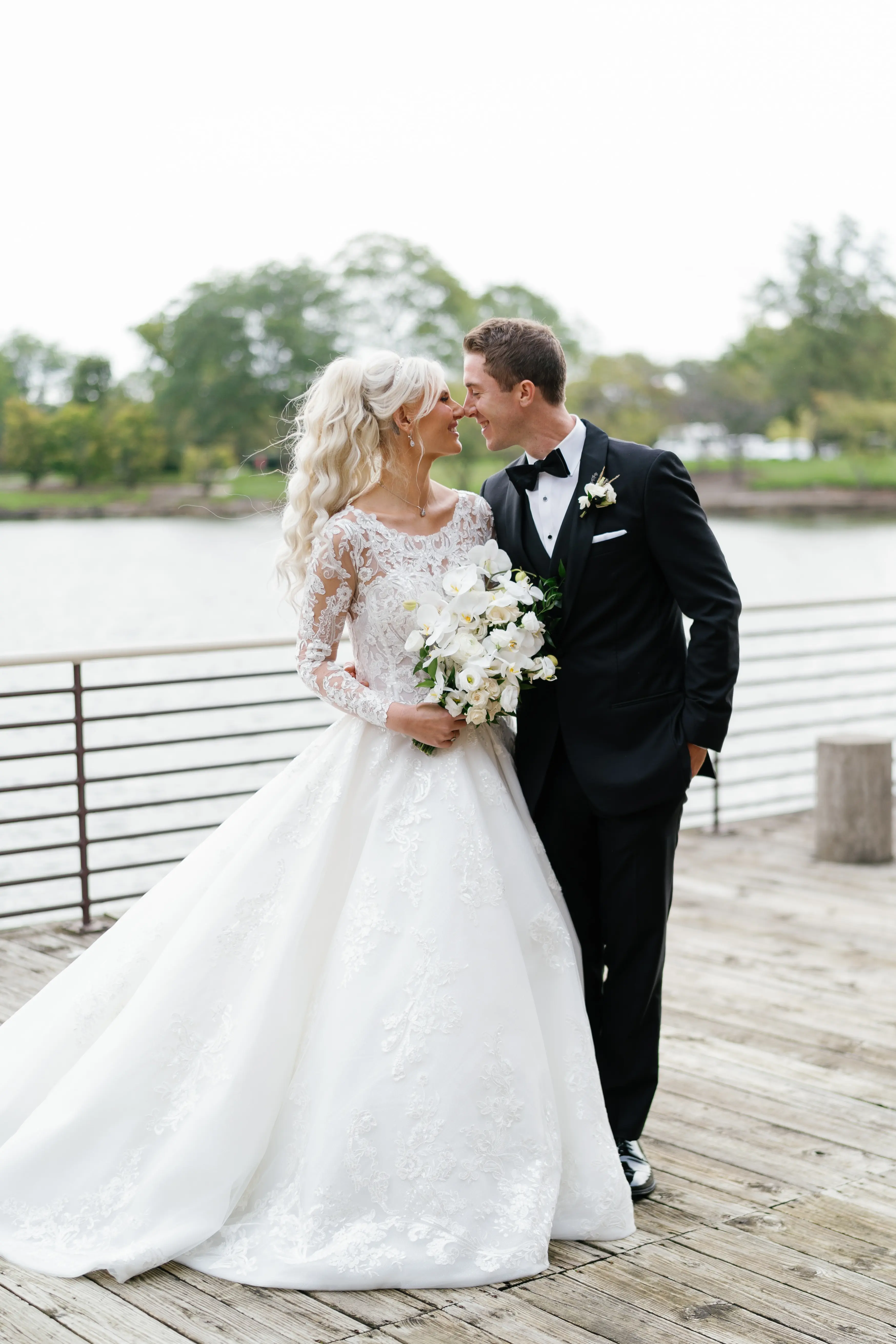 Bride Wearing Lace Princess Wedding Dress Called Norvinia By Sottero And Midgley With Groom On A Pier