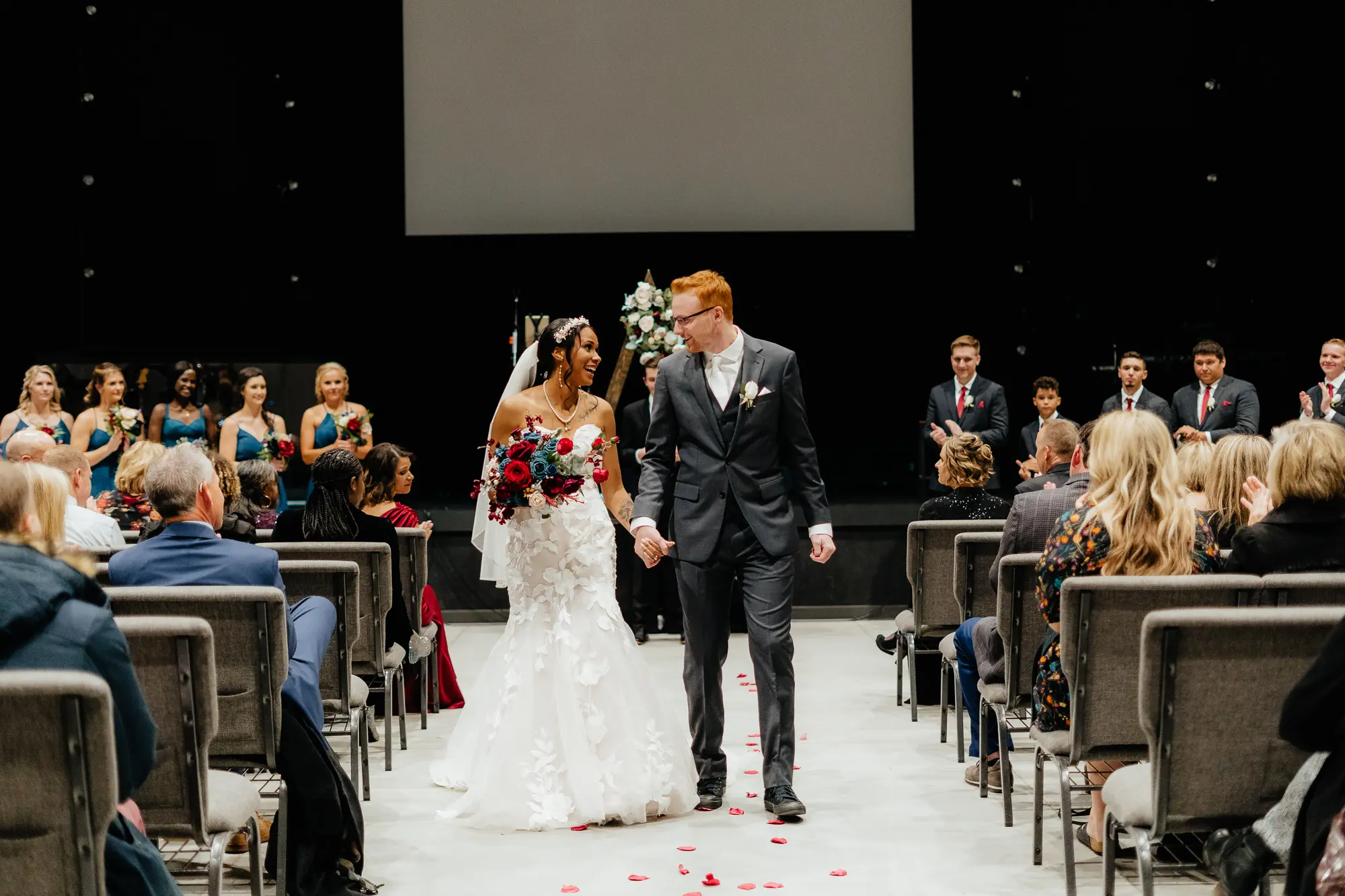 Bride Wearing Romantic Floral Wedding Dress Called Hattie By Rebecca Ingram With Groom At Wedding Ceremony