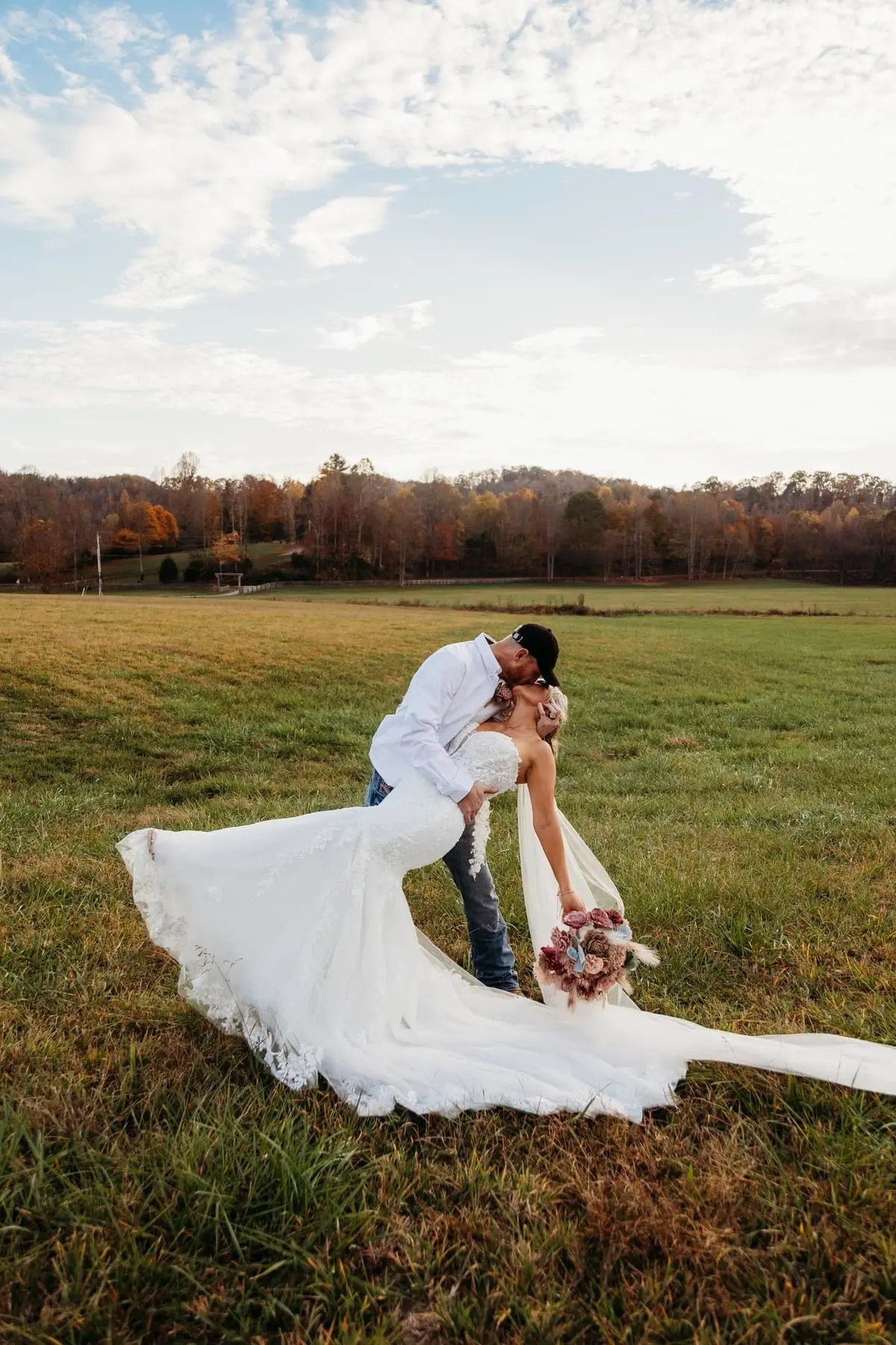 Bride wearing Lennon wedding dress by Maggie Sottero kissing her husband