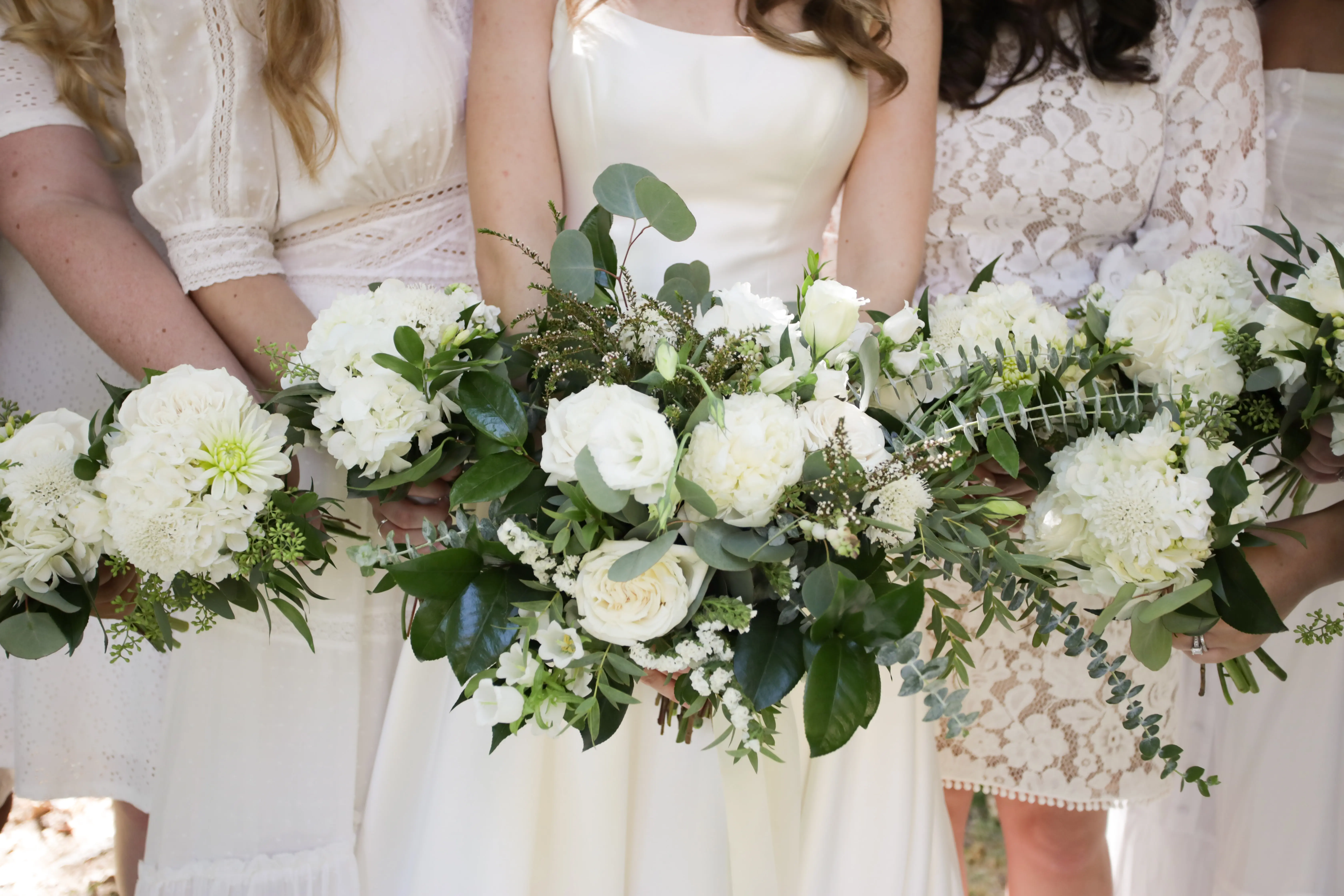 Bride wearing Simple Ballgown Wedding Dress called Selena by Maggie Sottero and showing off her green and white bouquet