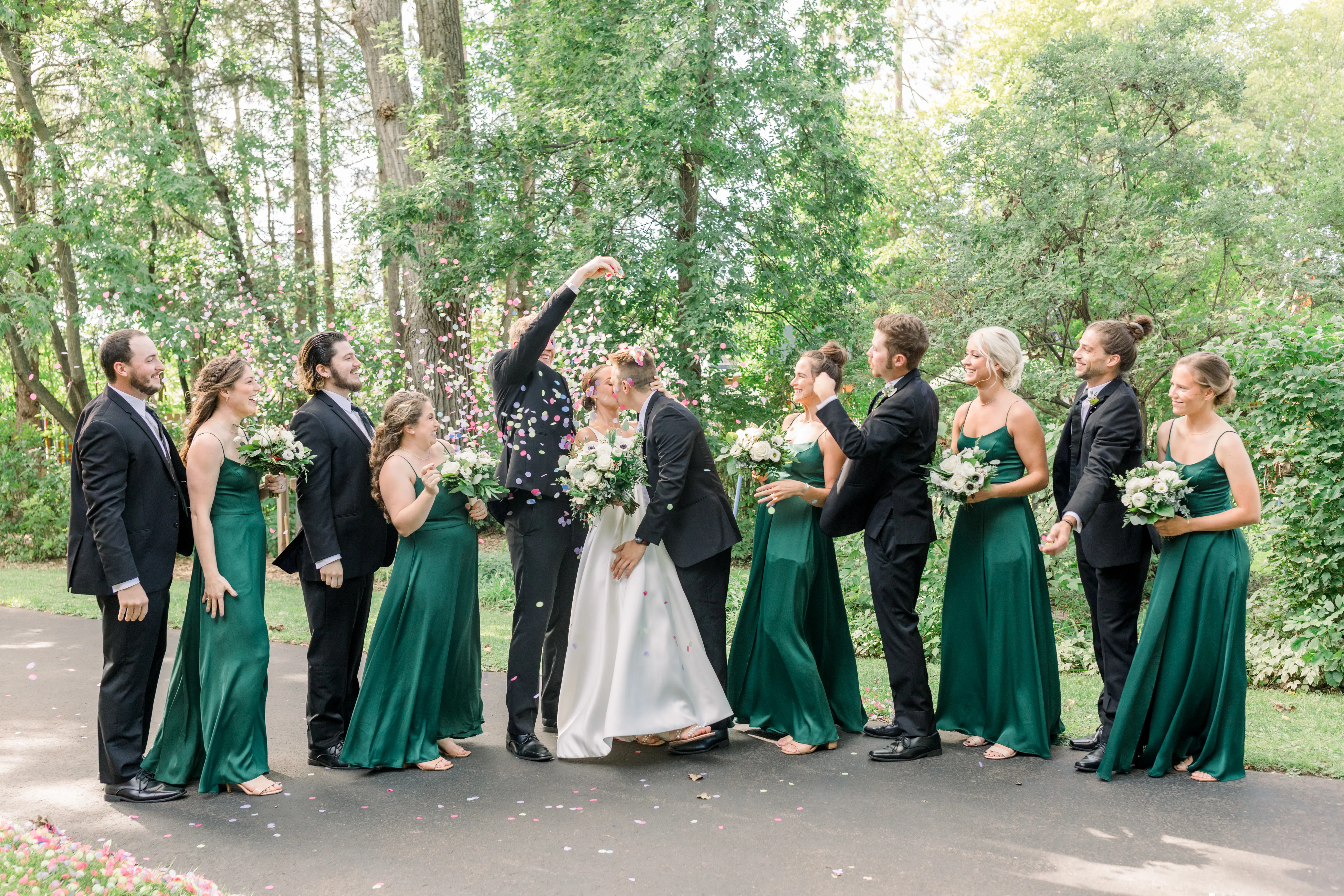 Bride Wearing Classic A-Line Wedding Dress Called Selena By Maggie Sottero With Bridal Party Throwing Rose Petals