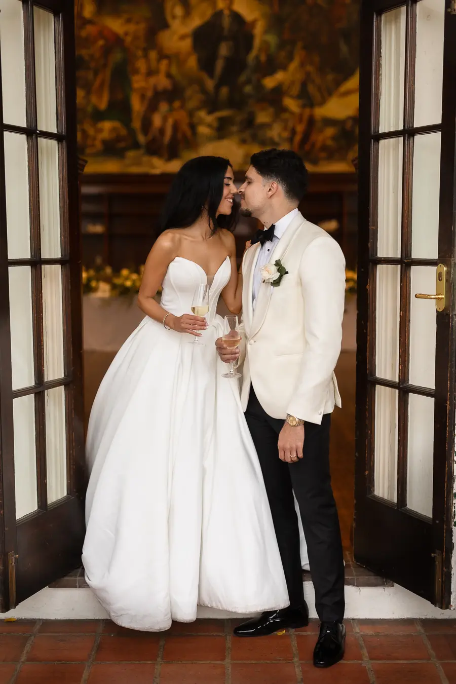 Bride wearing Derrick by Maggie Sottero kissing her husband