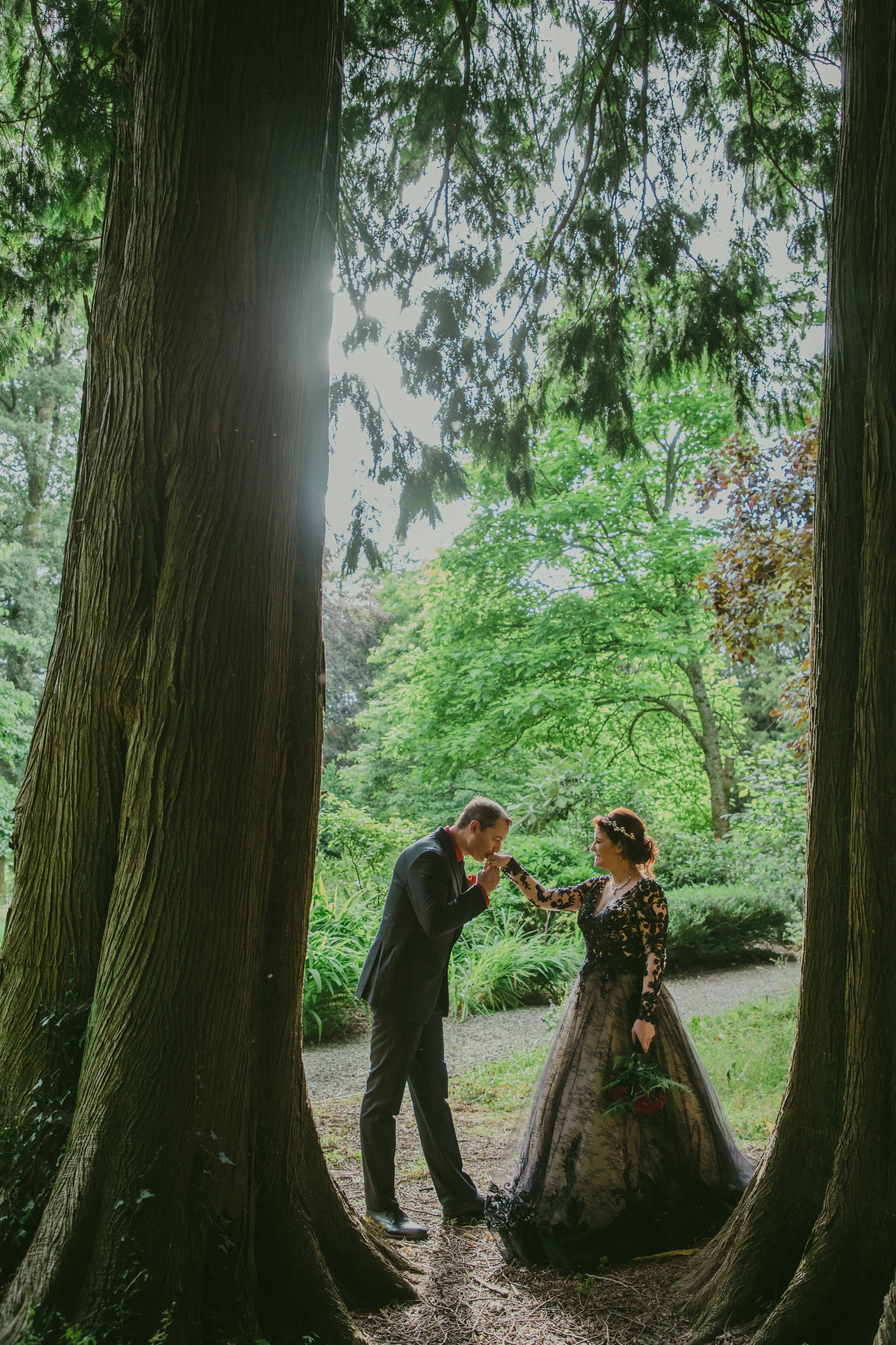 Bride wearing Zander wedding dress by Sottero and Midgley with her husband kissing her hand