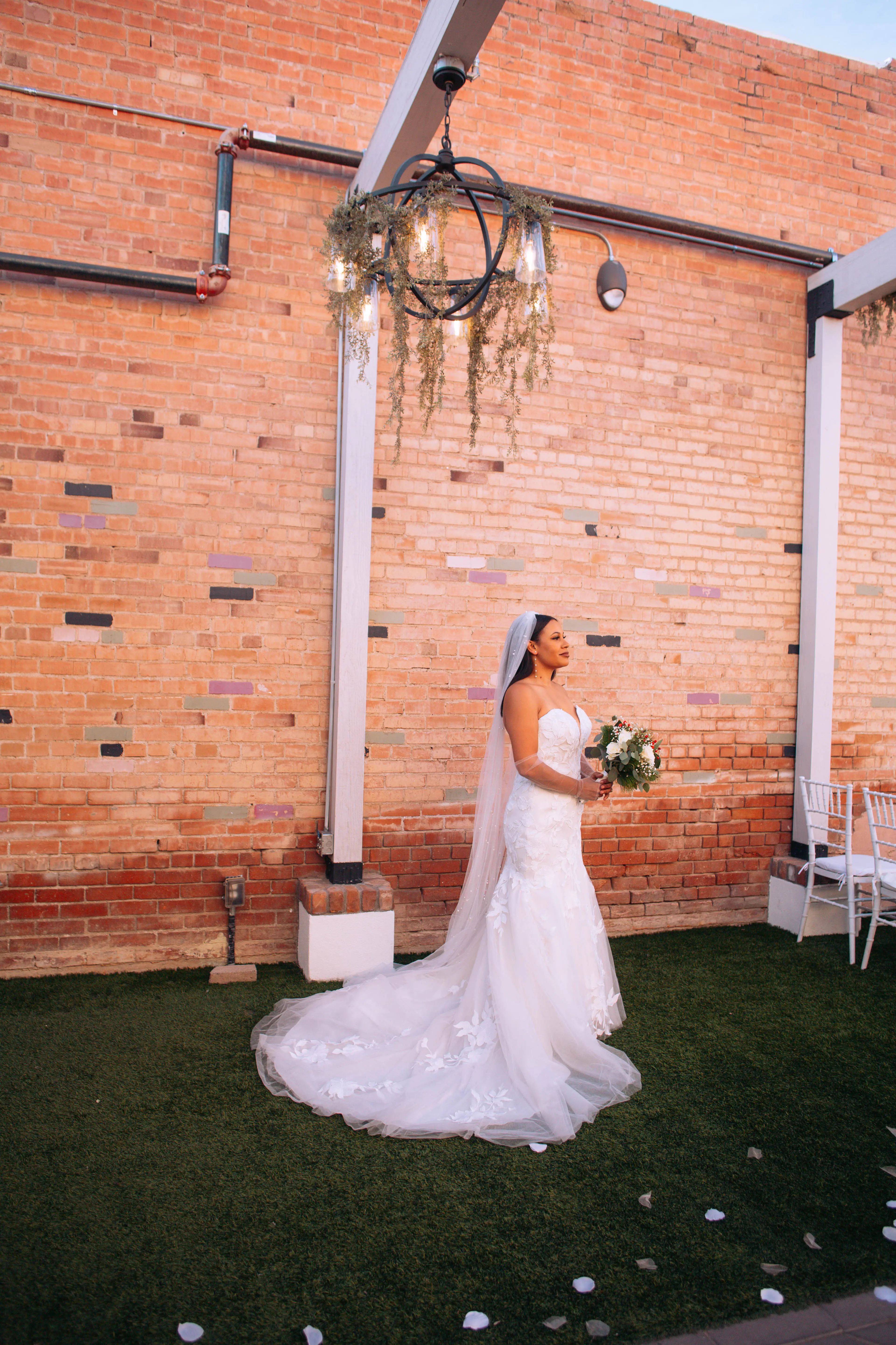 bride in floral lace train wedding dress called hattie by rebecca ingram