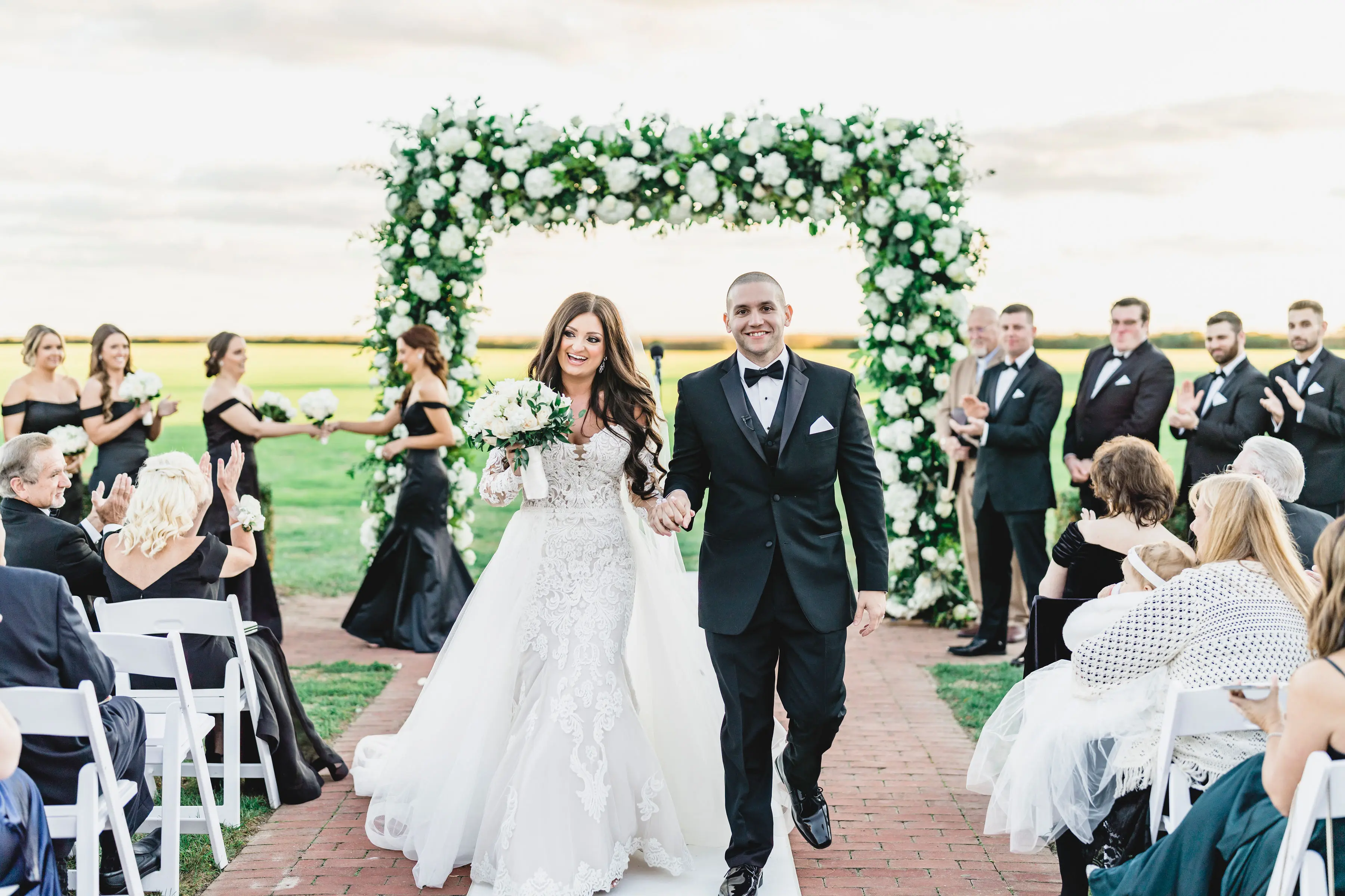 Bride Wearing Sparkly Lace Fit-and-Flare Wedding Dress with Groom Walking Down Aisle.