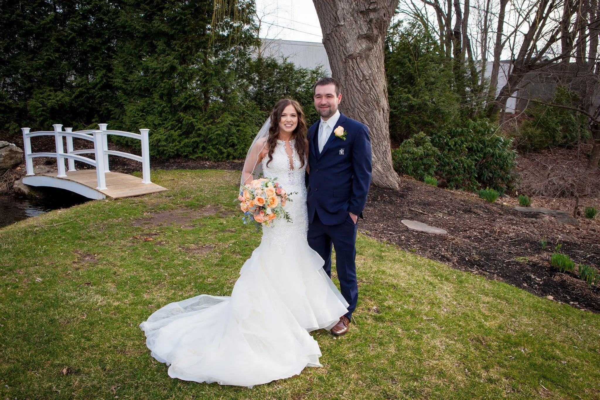 Bride with groom wearing organza mermaid wedding dress