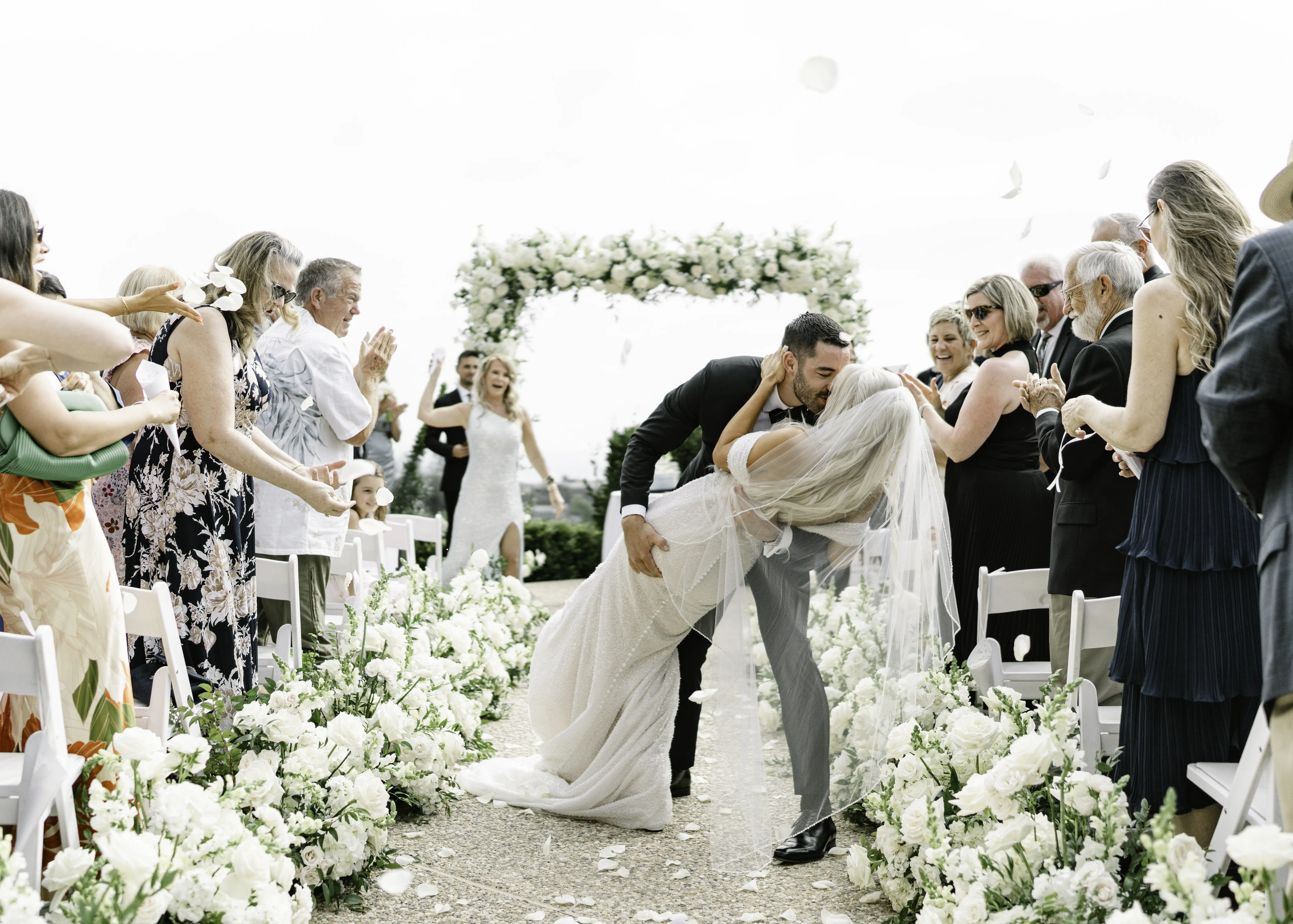 Bride Wearing Pearl Sparkly Bridal Gown Called Drew By Maggie Sottero Kissing Groom