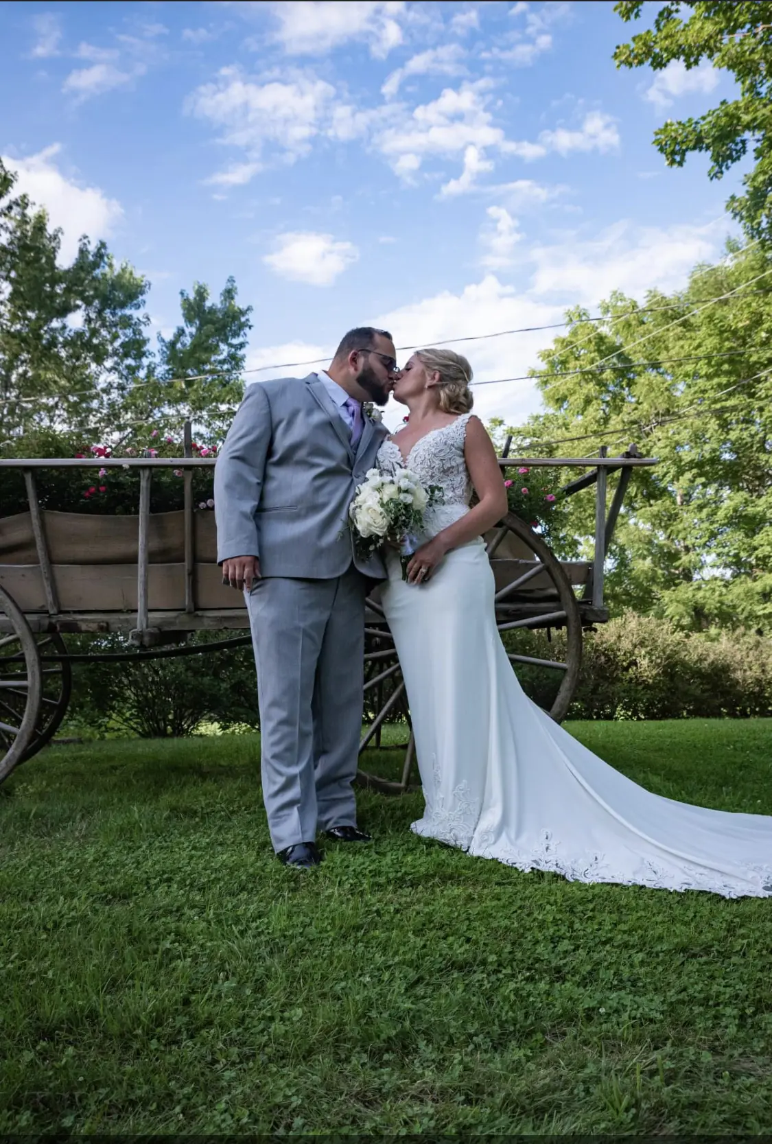 Bride with groom wearing lace crepe wedding dress