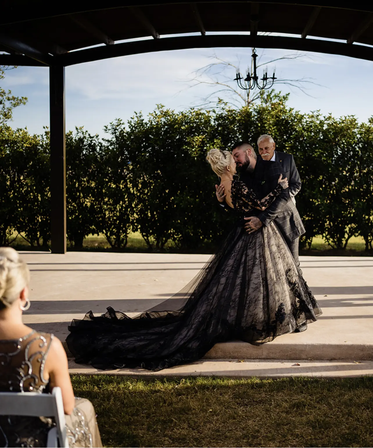 Bride Wearing Black Lace Wedding Dress Called Zander By Sottero And Midgley Kissing Groom