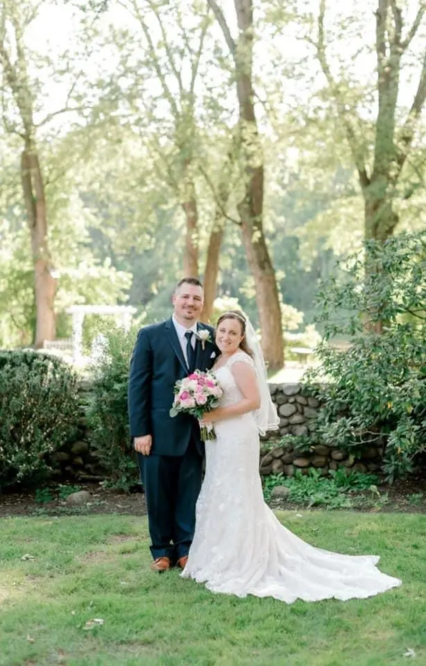 Groom and Bride Wearing a Classic Lace Wedding Dress Called Brenda by Rebecca Ingram
