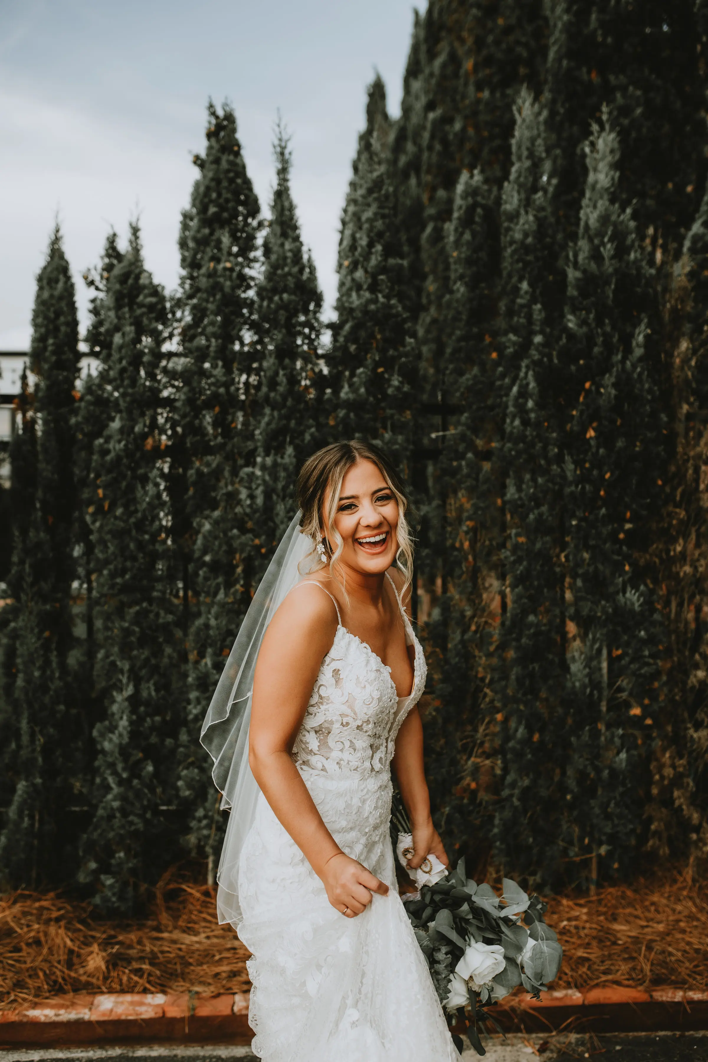 Bride in romantic lace sheath wedding dress