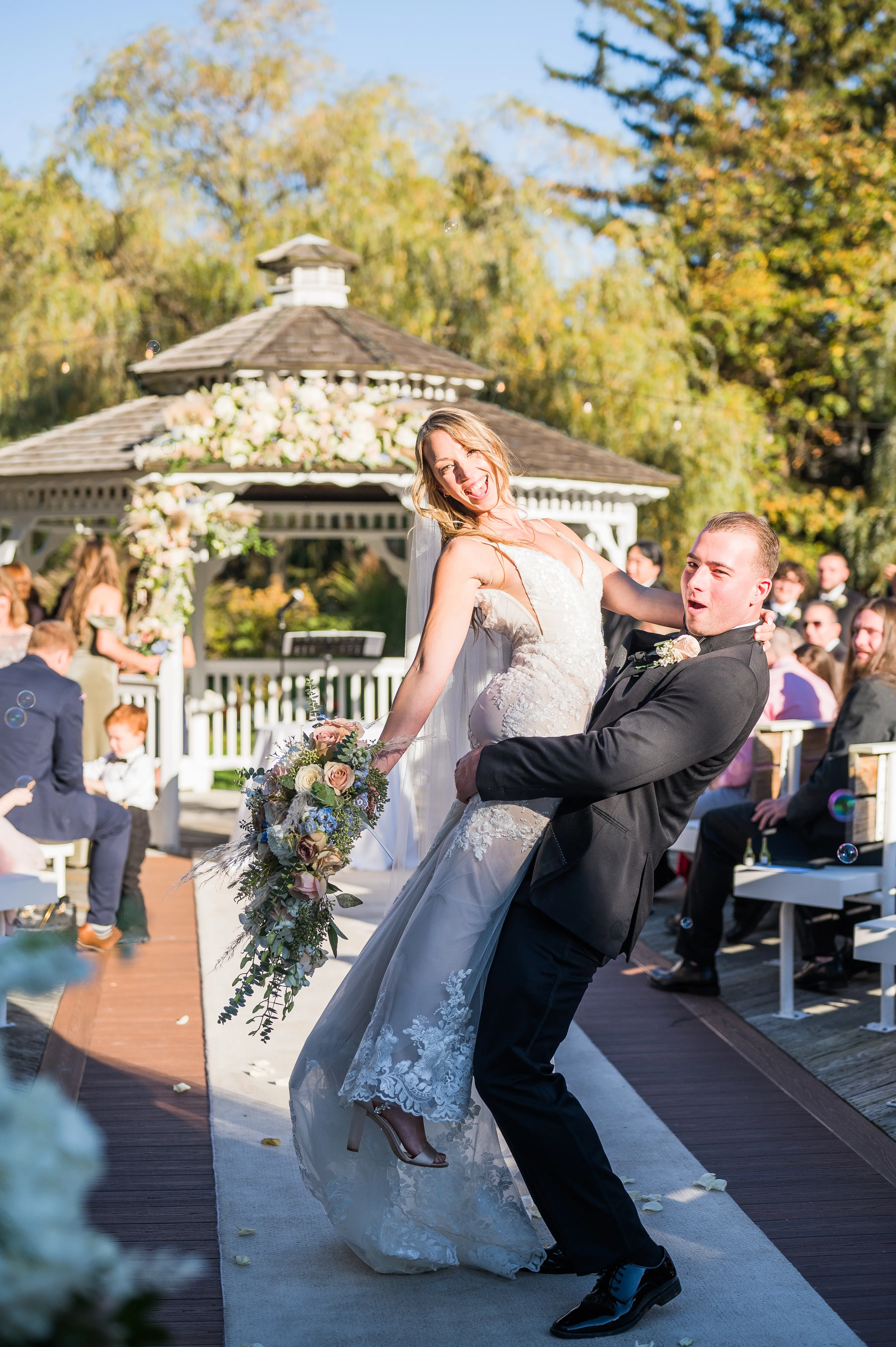 Real bride in sparkly lace fit-and-flare bridal gown with lace motifs over tulle called Fontaine by Maggie Sottero