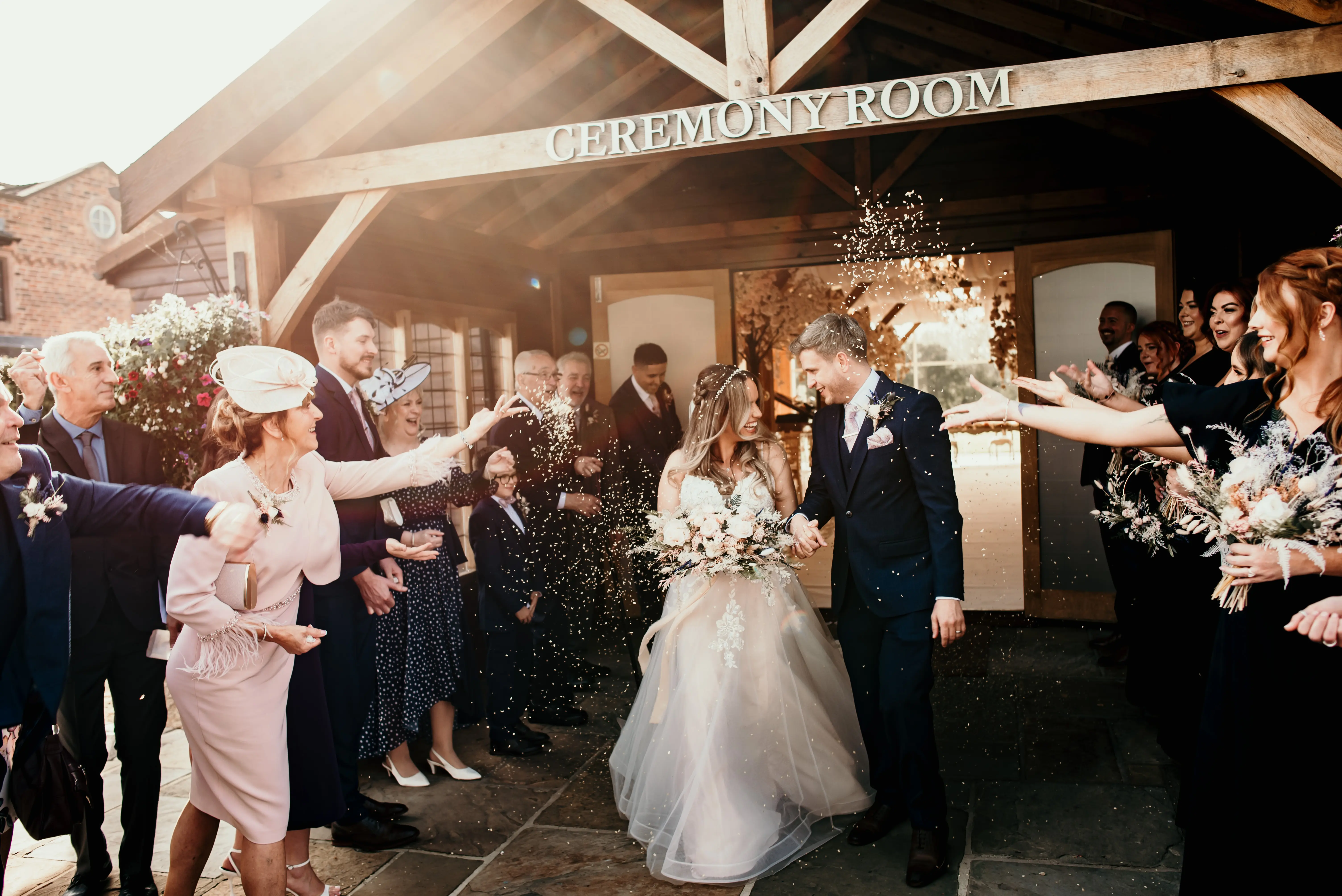 Bride wearing Stevie wedding gown by Maggie Sottero and her husband at their exit