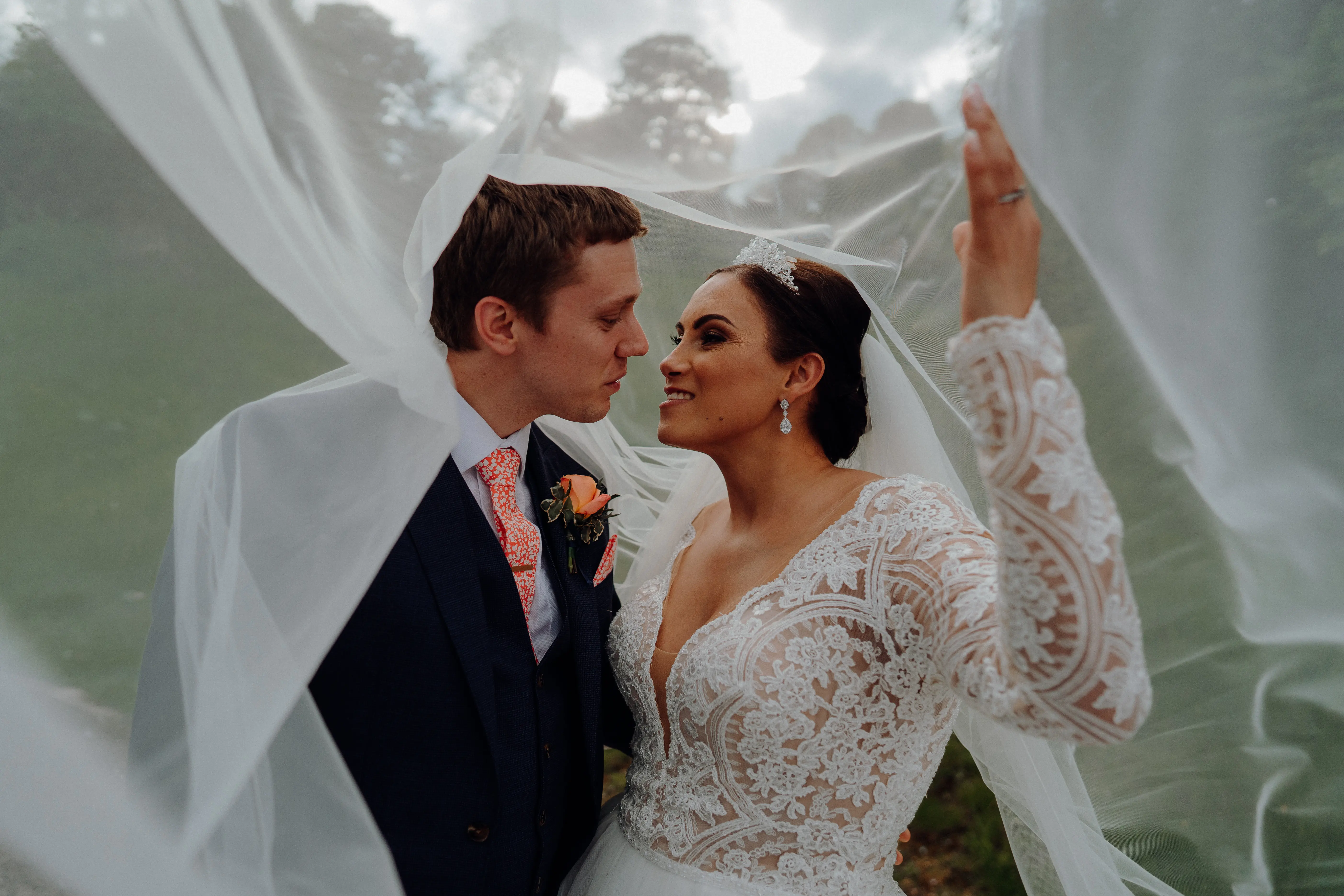 Groom Looking At Bride In Long Sleeve Lace Ball Gown Wedding Dress Called Mallory Dawn By Maggie Sottero