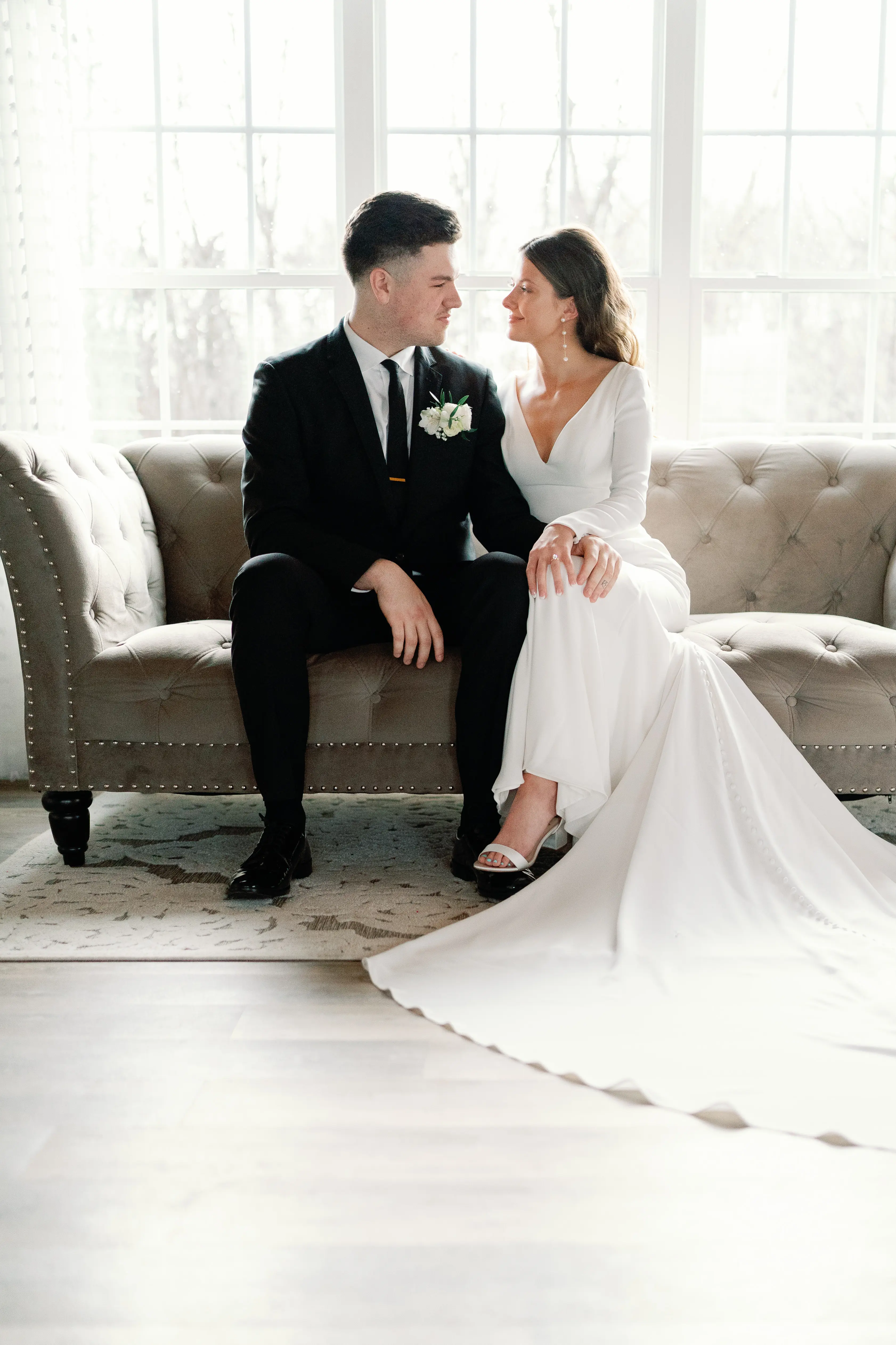 Bride wearing Fernanda wedding dress by Maggie Sottero smiling at her husband
