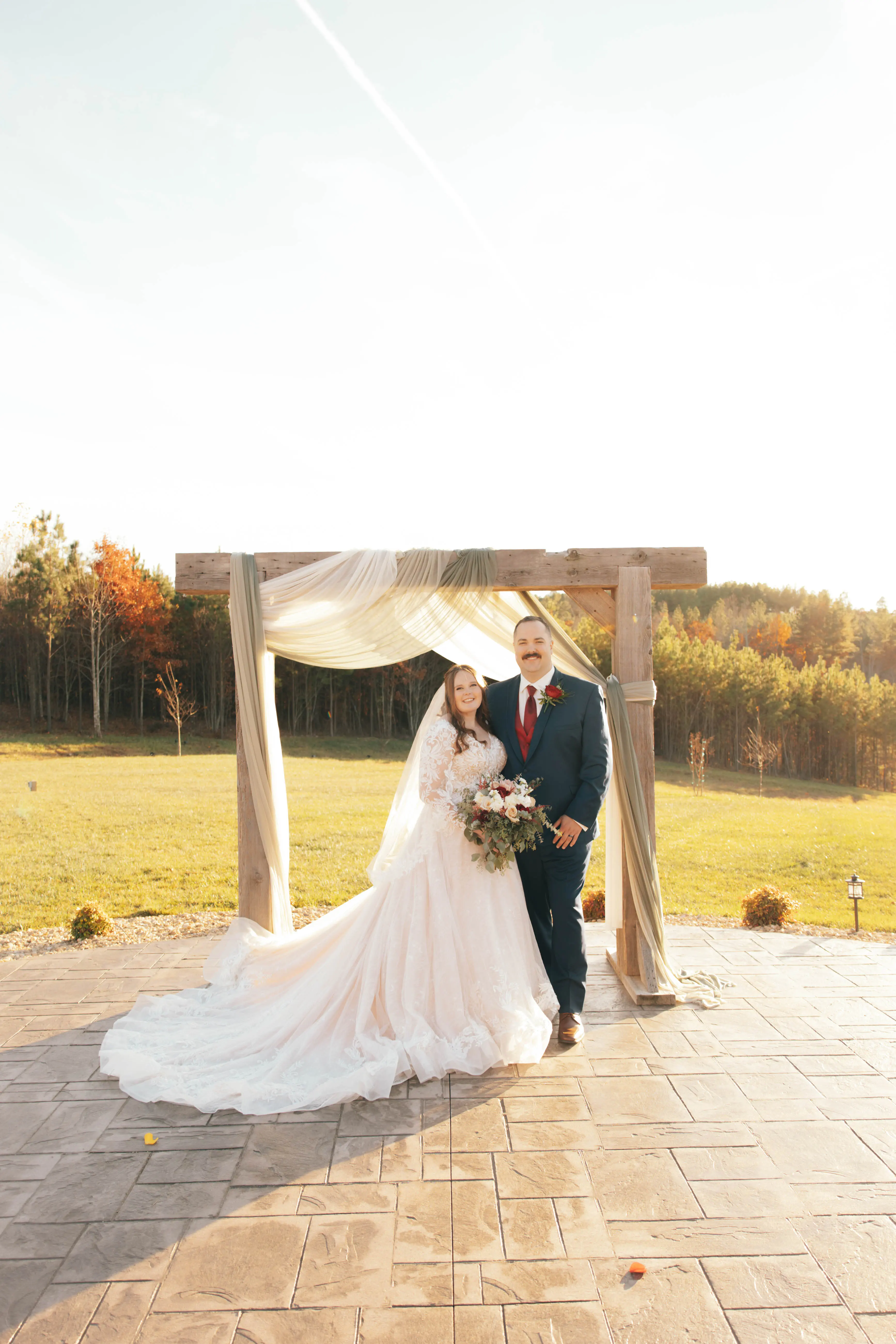 Bride wearing Zander wedding gown by Sottero and Midgley with her husband