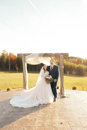 Bride wearing Zander wedding gown by Sottero and Midgley with her husband