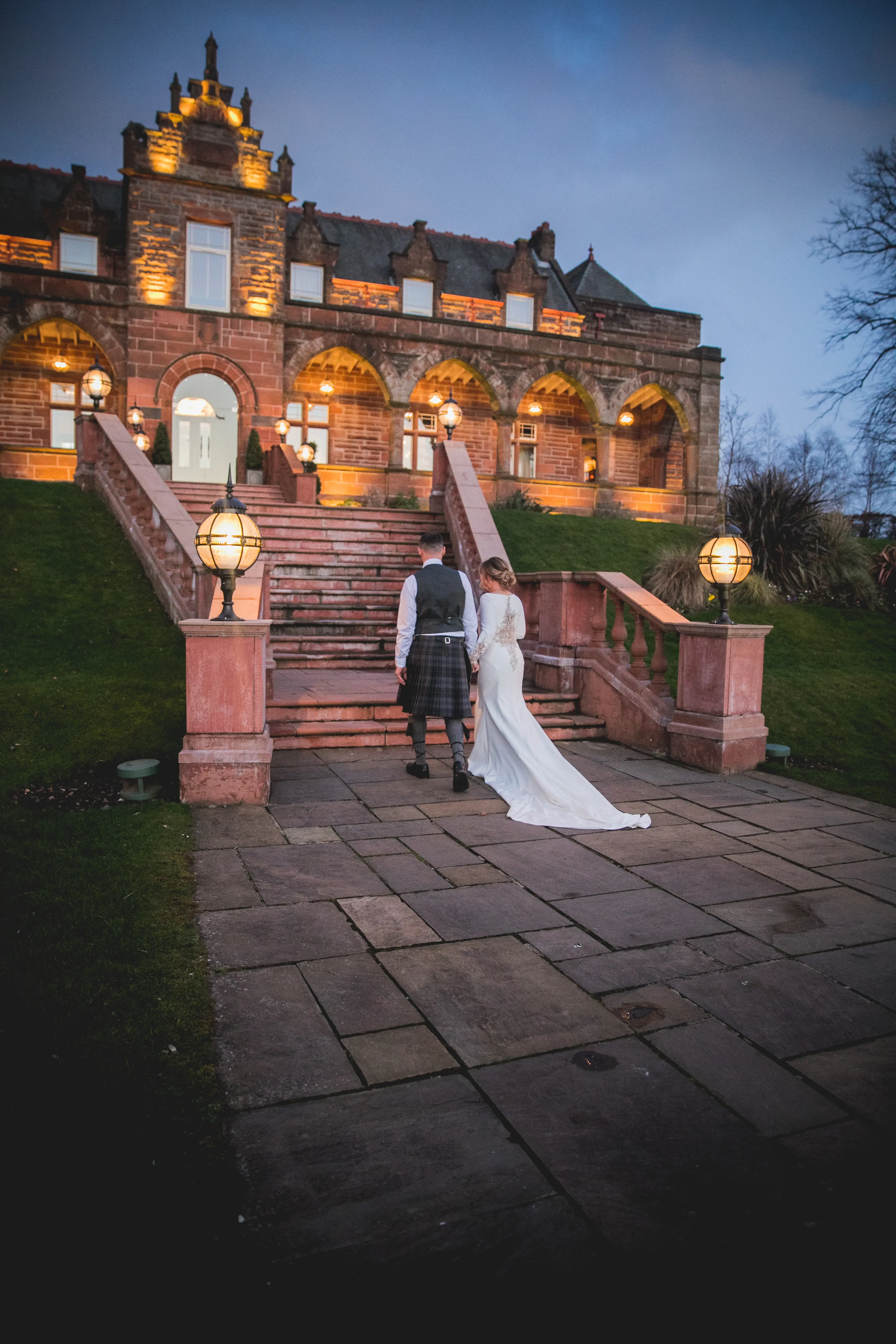 Groom with Bride in Crepe Fit-and-Flare Wedding Dress with Beaded Illusion Embroidery Featuring Swarovski Crystals Called Aston by Sottero & Midgley