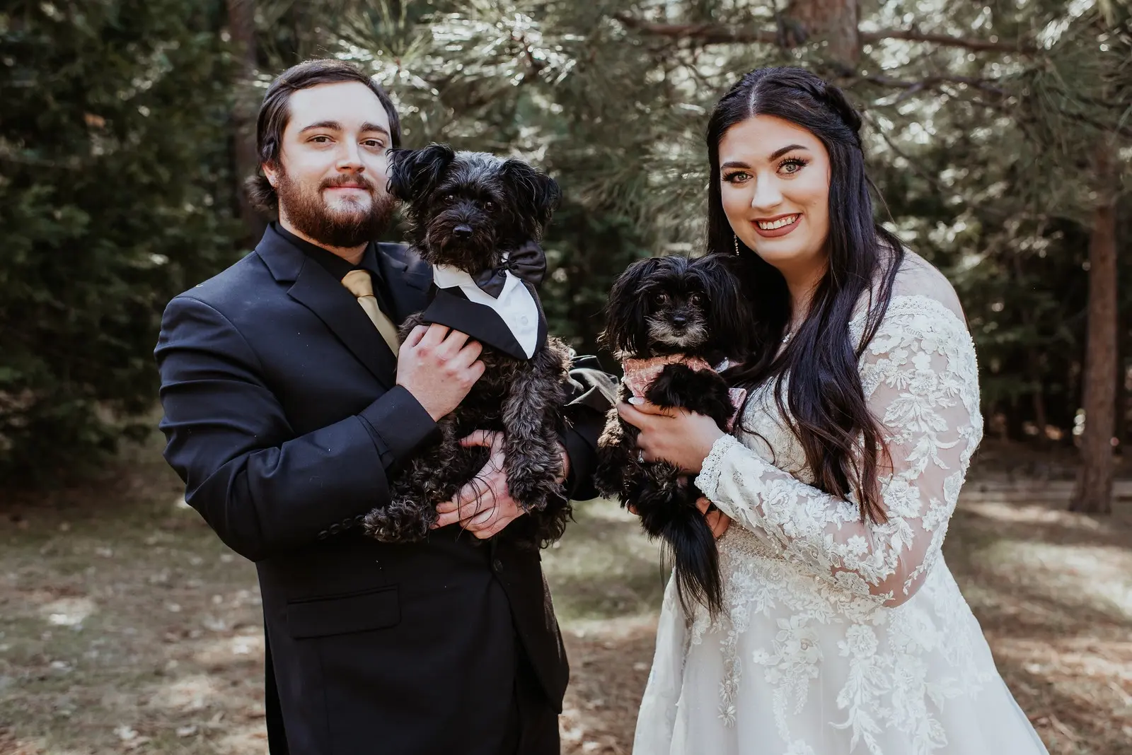 Bride Wearing Long Sleeve Lace Wedding Dress Called Raphael By Maggie Sottero And Groom Holding Their Dogs
