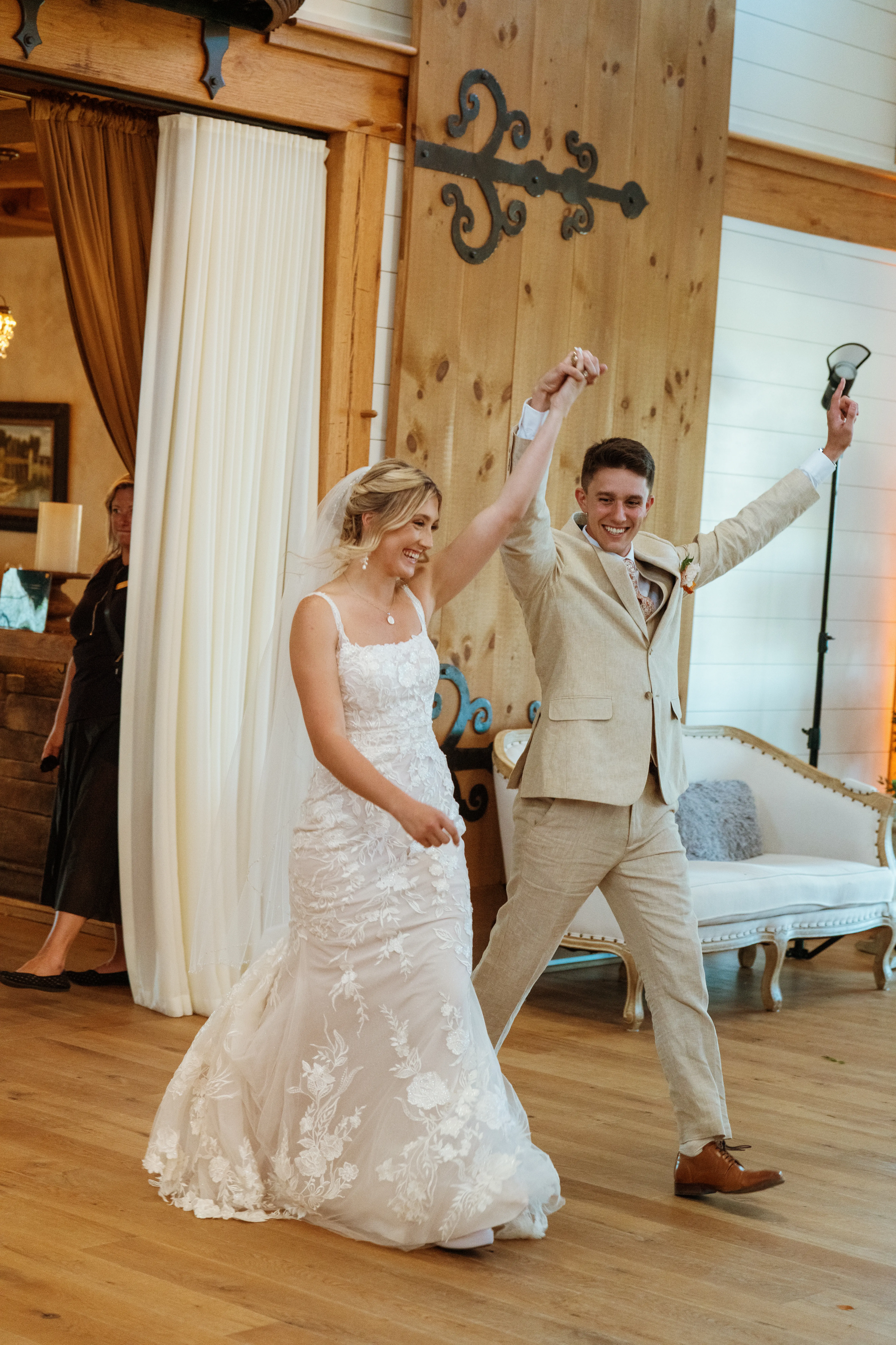 Bride wearing Albany wedding dress by Maggie Sottero celebrating with her husband