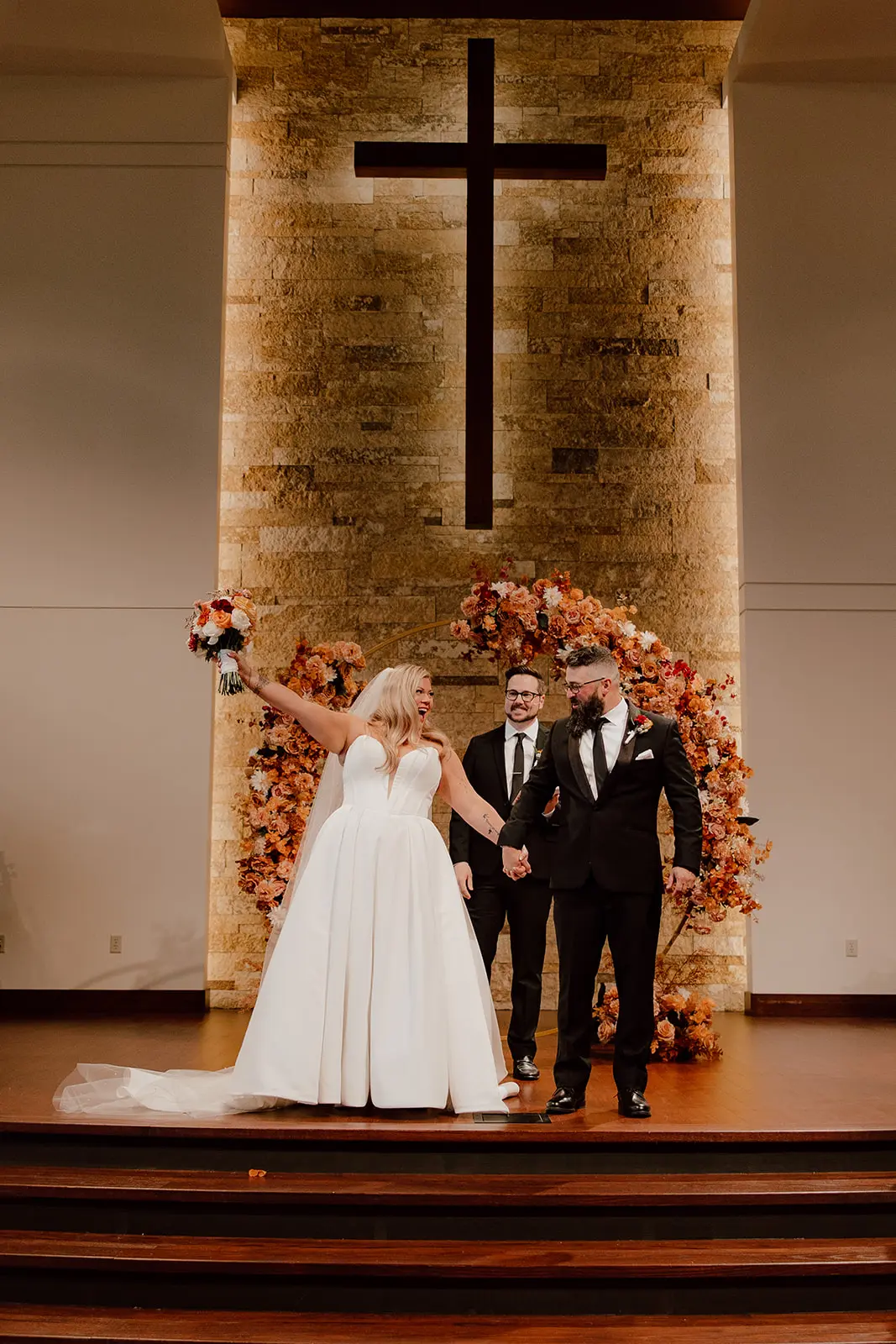 Bride wearing Derrick by Maggie Sottero and her husband after their ceremony