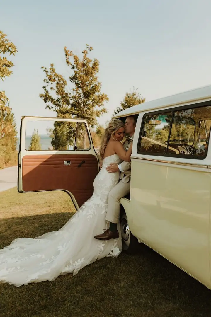 Bride wearing Hattie wedding dress by Rebecca Ingram next to a van with her husband