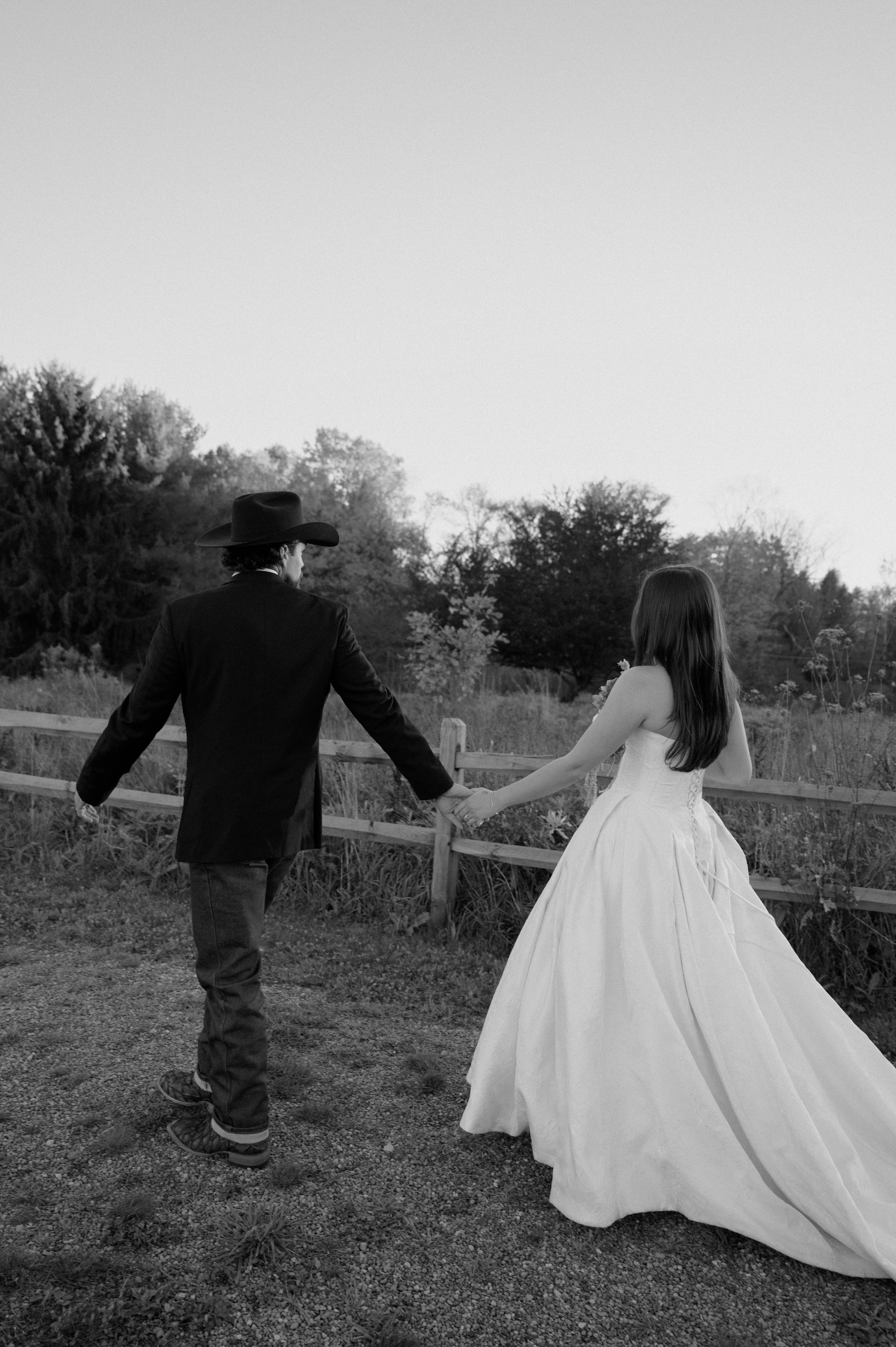Bride Wearing Jacquard Ballgown Wedding Dress Called Fortune Marie By Maggie Sottero holding hands and walking with groom