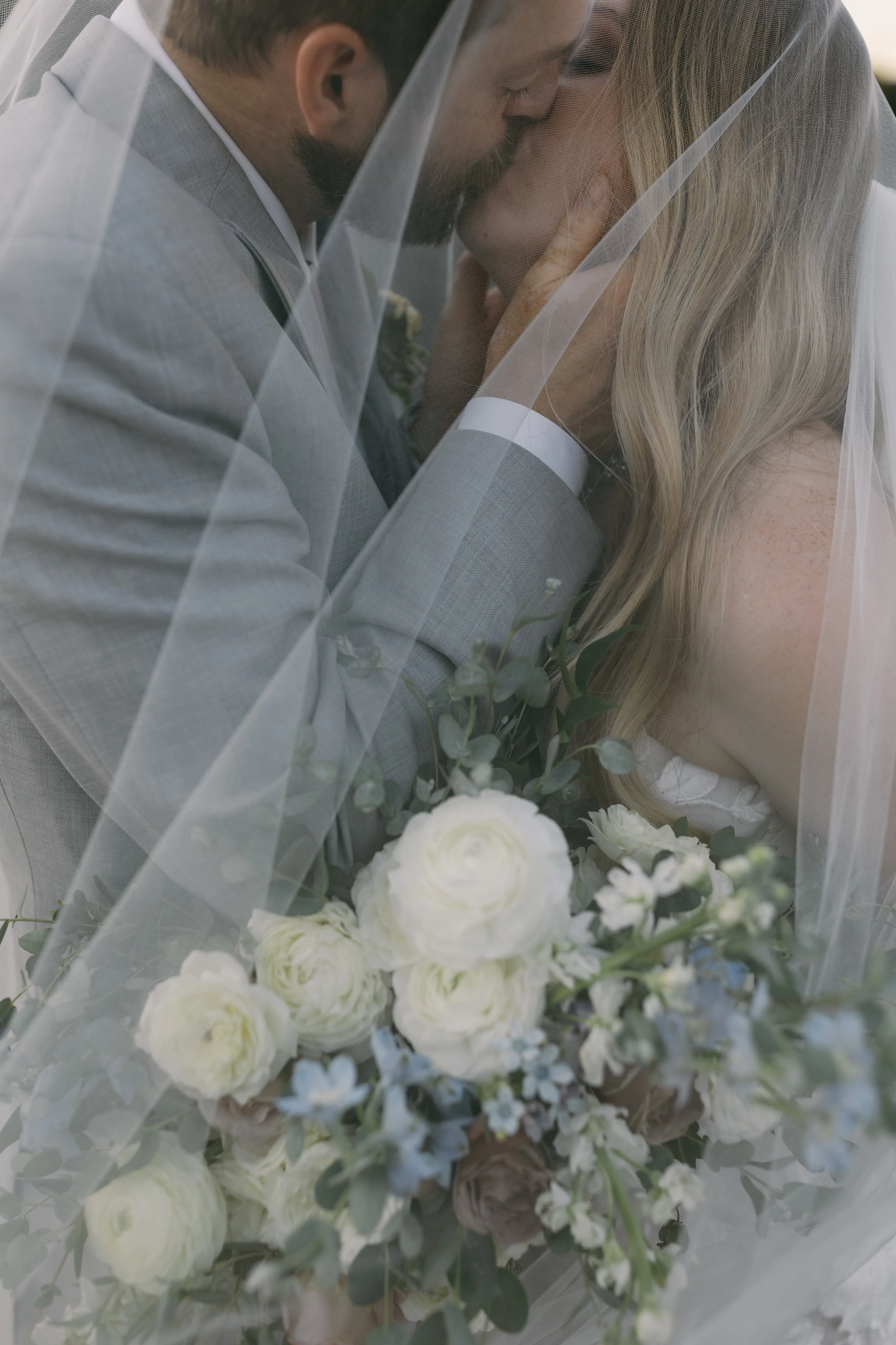 Bride in Strapless Mermaid Wedding Dress Named Hattie By Rebecca Ingram Groom Kissing Bride