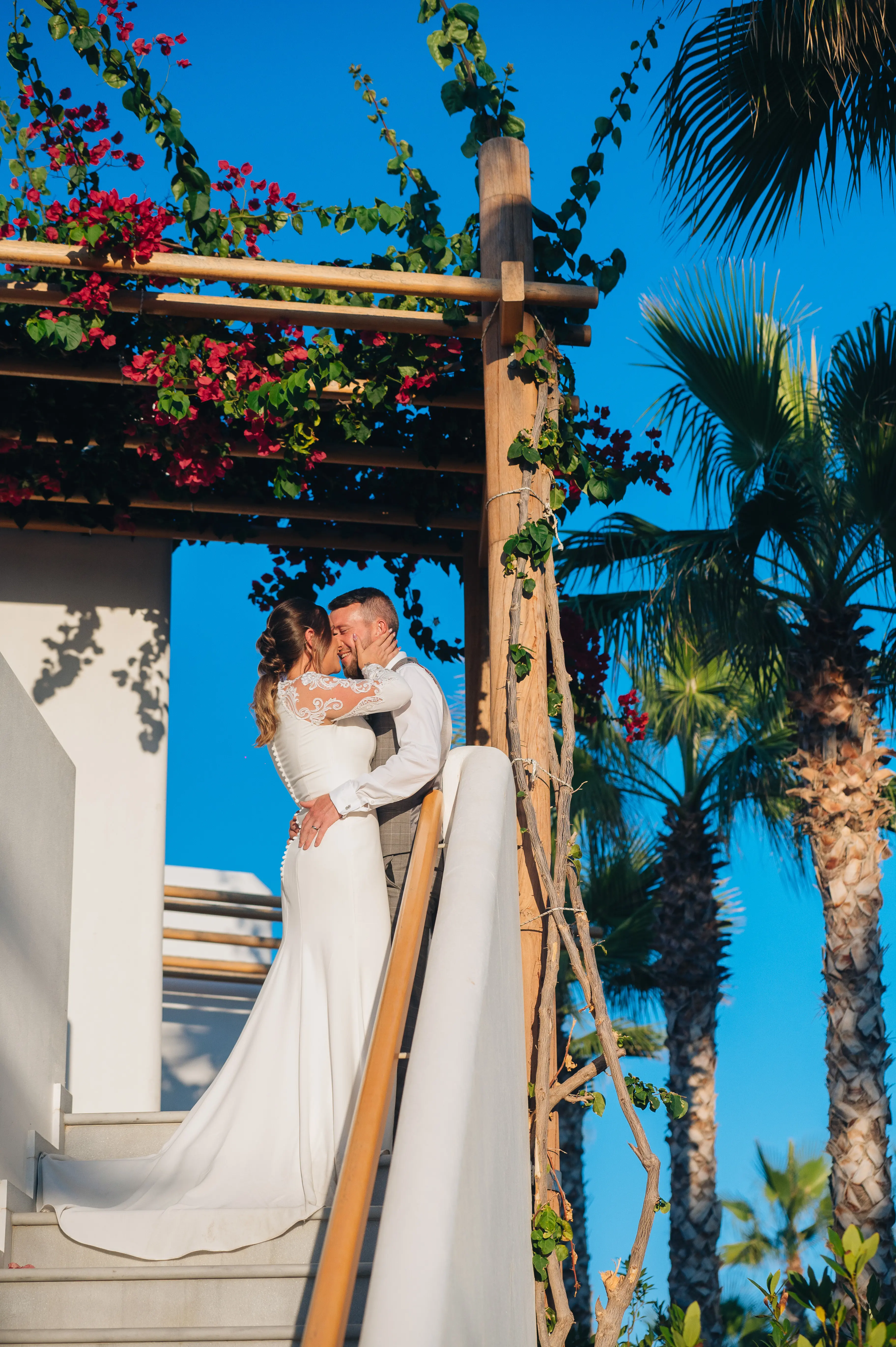 Groom with Real Bride in Minimalist Crepe Long Sleeve Lace Sheath Wedding Dress Called Bethany by Rebecca Ingram