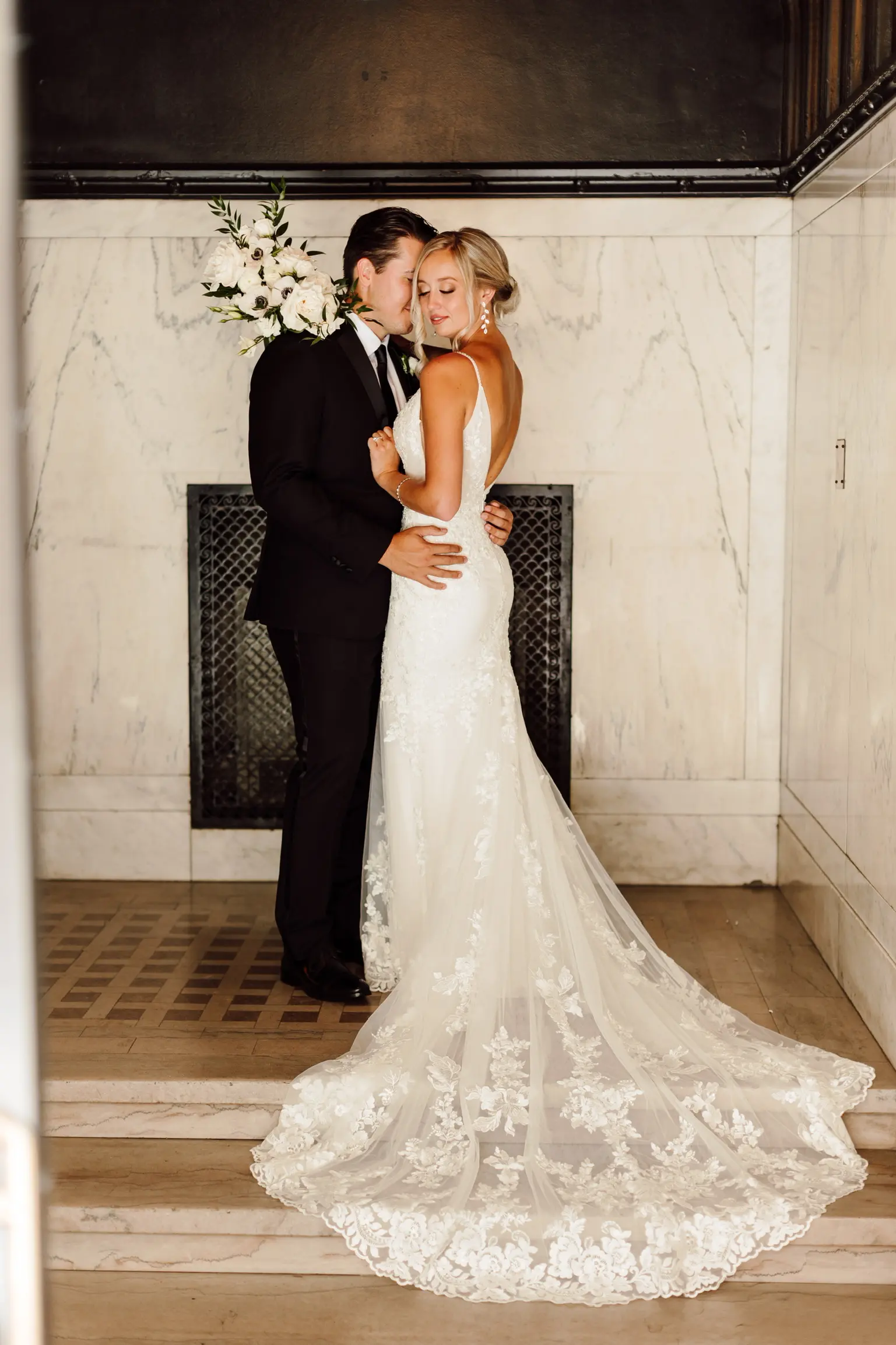 Bride Wearing Sparkle Lace Long Train Wedding Dress Called Fontaine By Maggie Sottero With Groom On Stairs