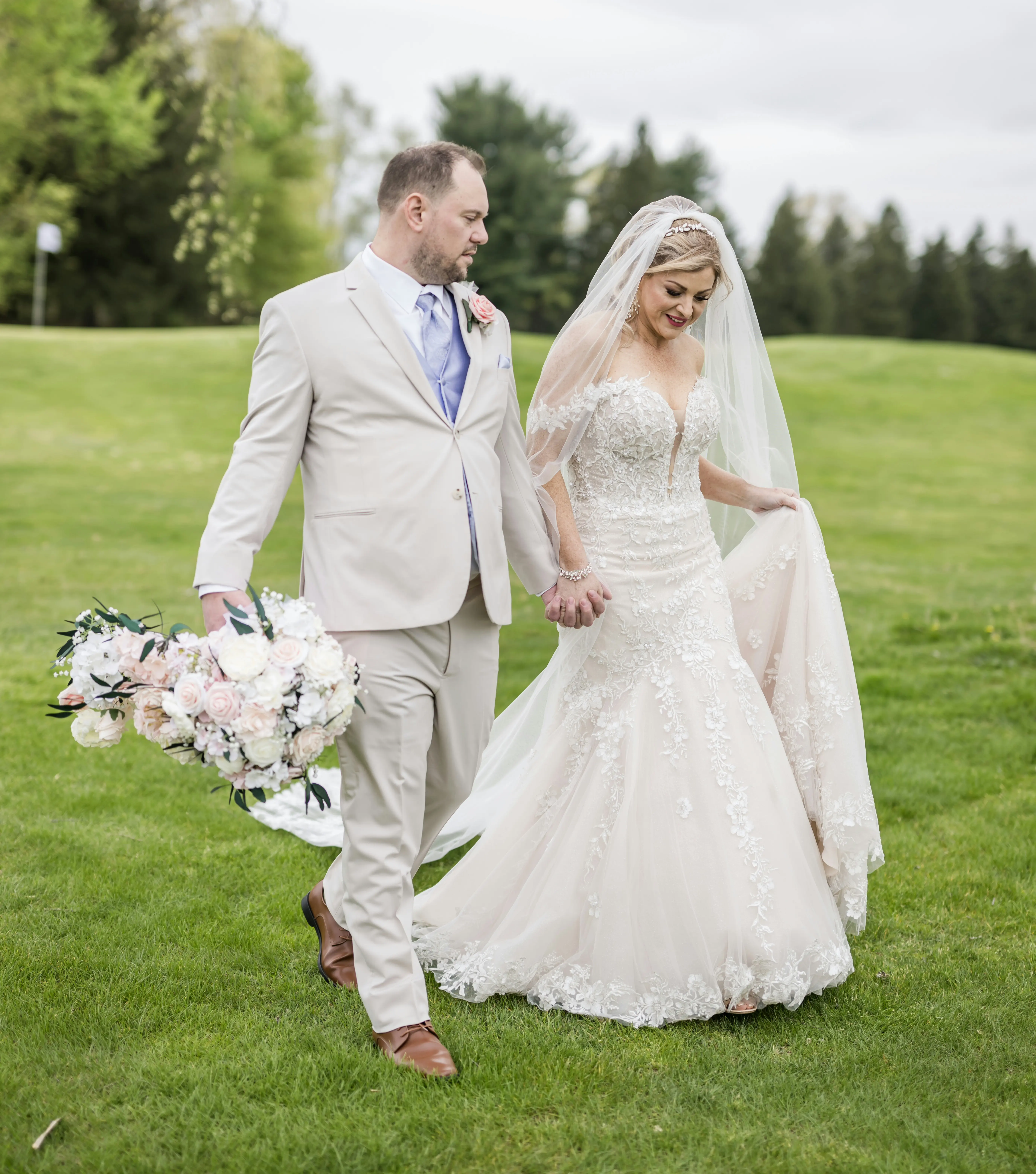 Bride wearing Lennon by Maggie Sottero walking with her husband