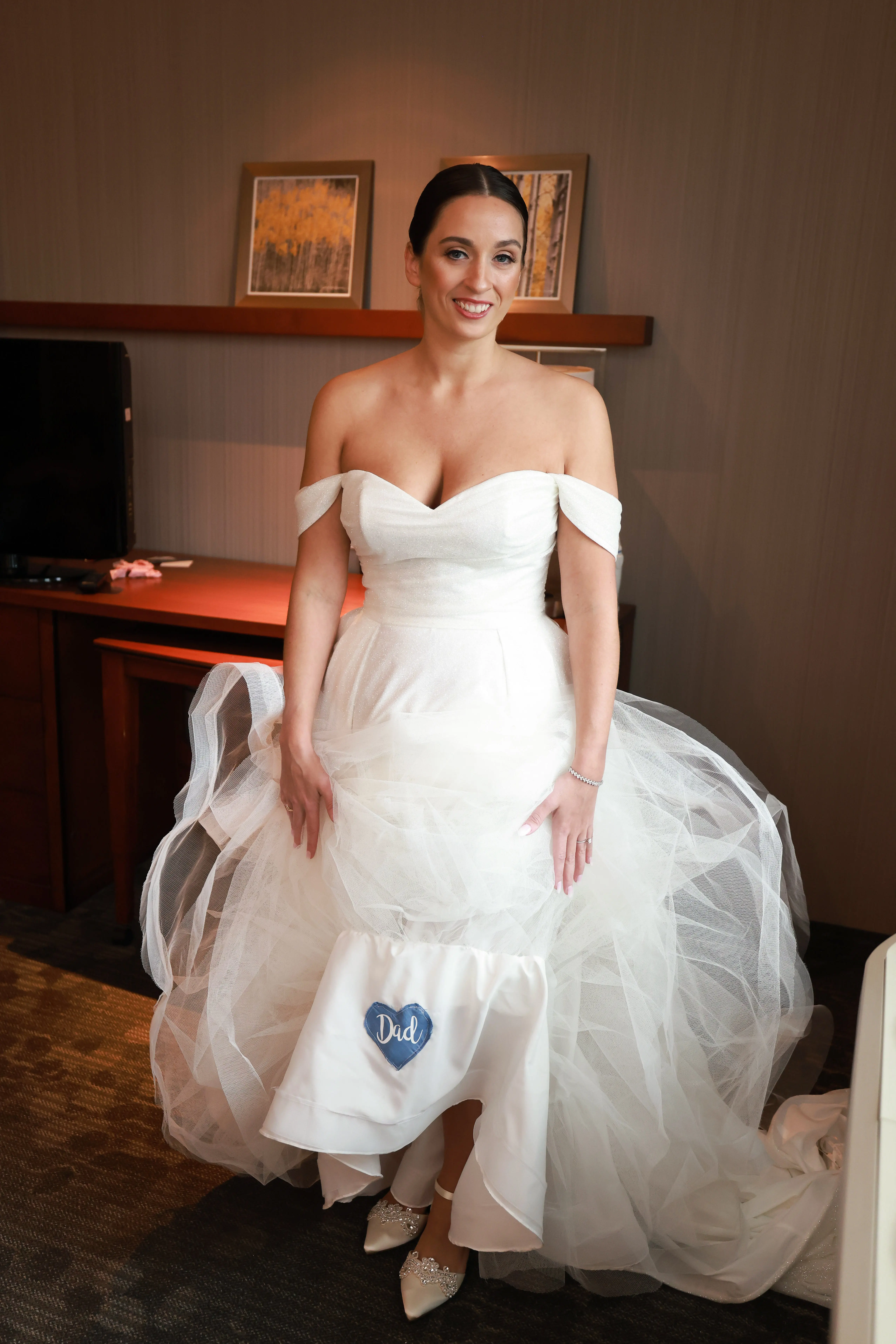 Bride wearing Anniston wedding dress by Sottero and Midgley showing off a colorful patch