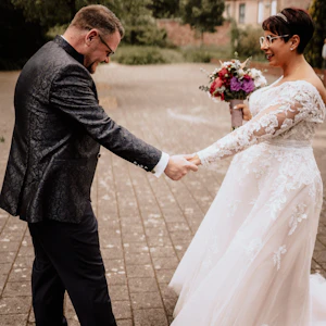Bride in Long Sleeve Ivory Wedding Dress Raphael with Groom